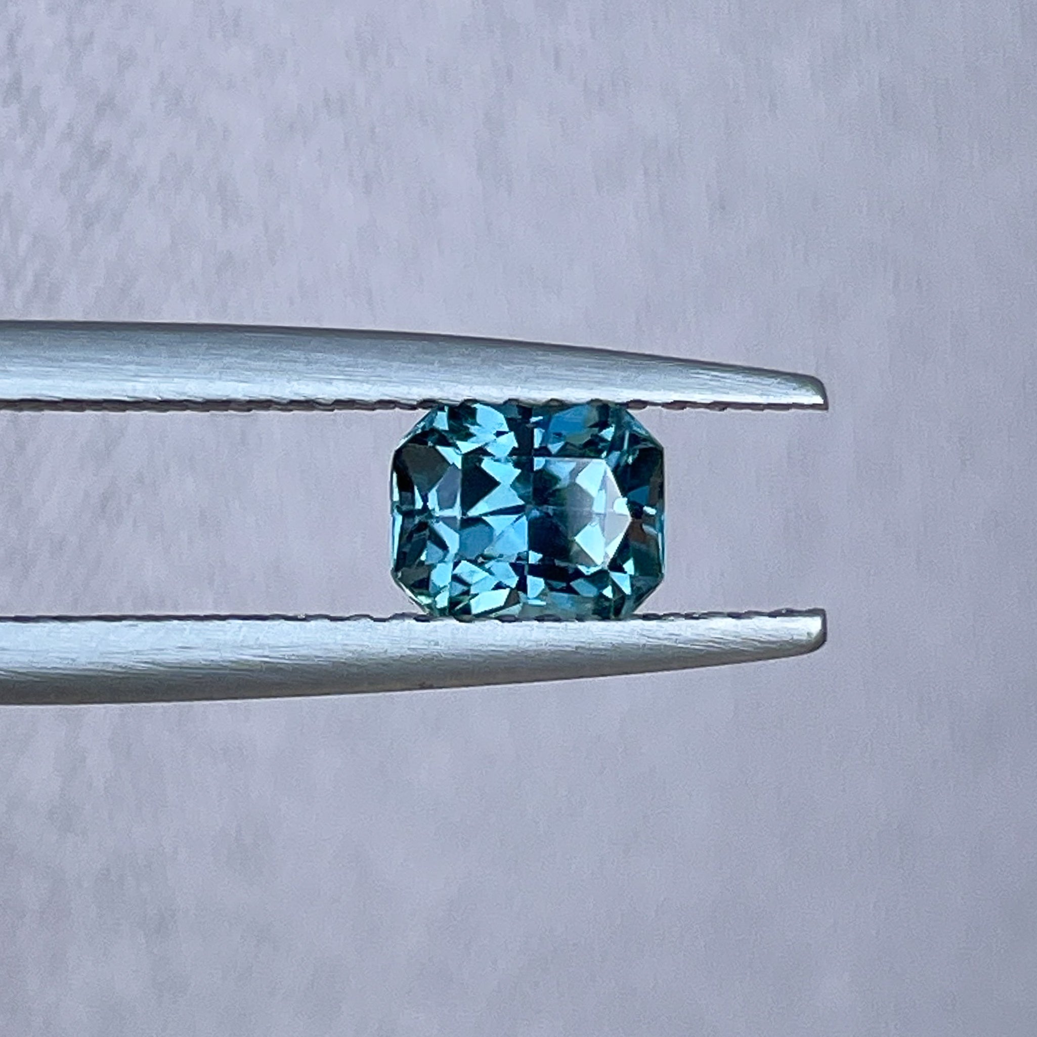 Natural teal blue sapphire 0.98 Ct radiant cut loose gemstone by NASHGEMS, ideal for engagement rings or custom jewelry.