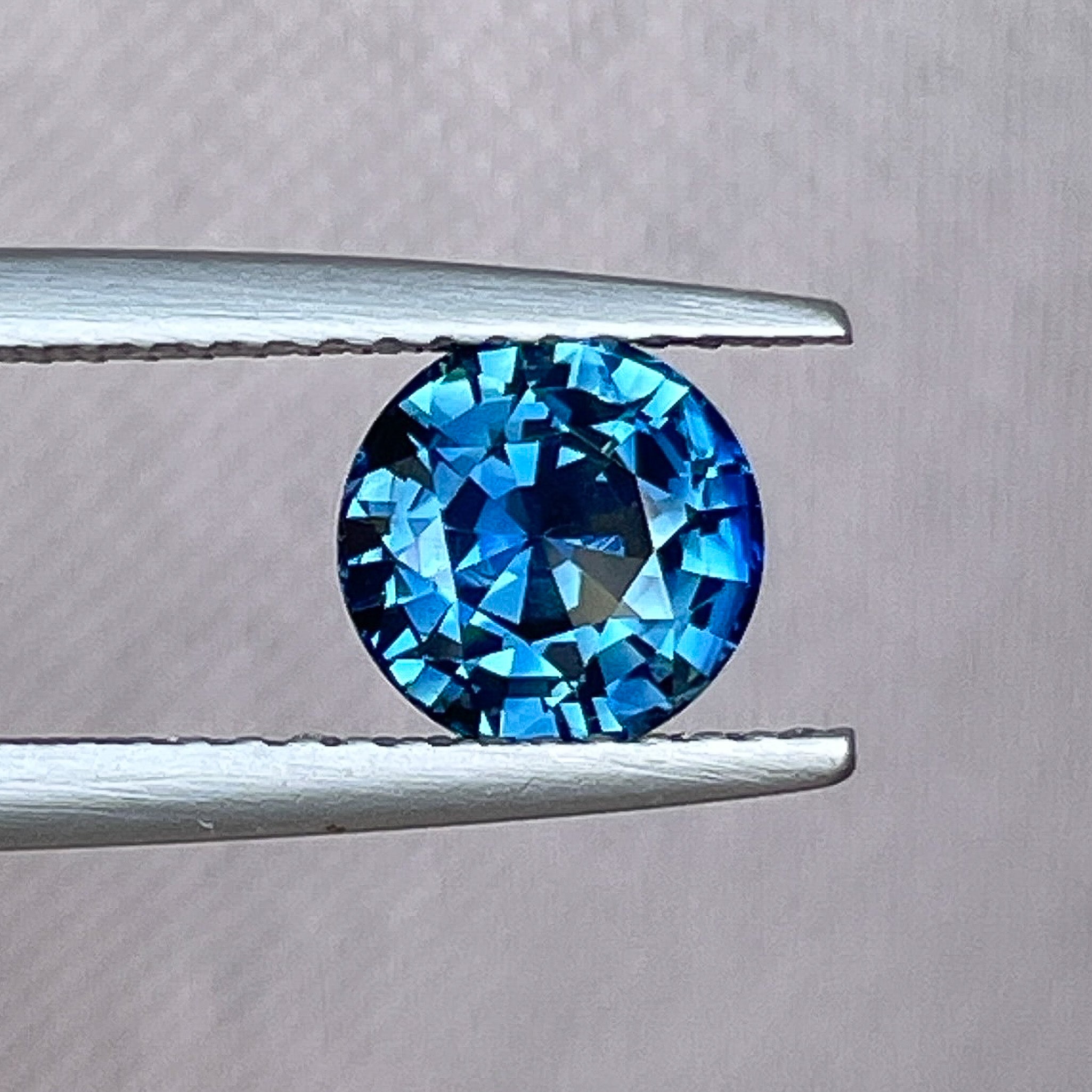 Natural teal blue sapphire, 1.65 ct round cut loose gemstone by NASHGEMS, ideal for engagement rings or custom jewelry.