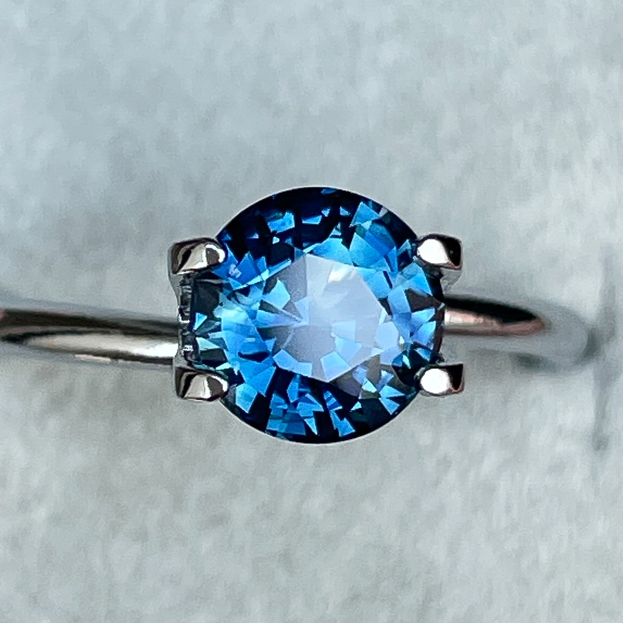 Natural teal blue sapphire 1.65 ct round cut loose gemstone from NASHGEMS, ideal for engagement rings or custom jewelry.