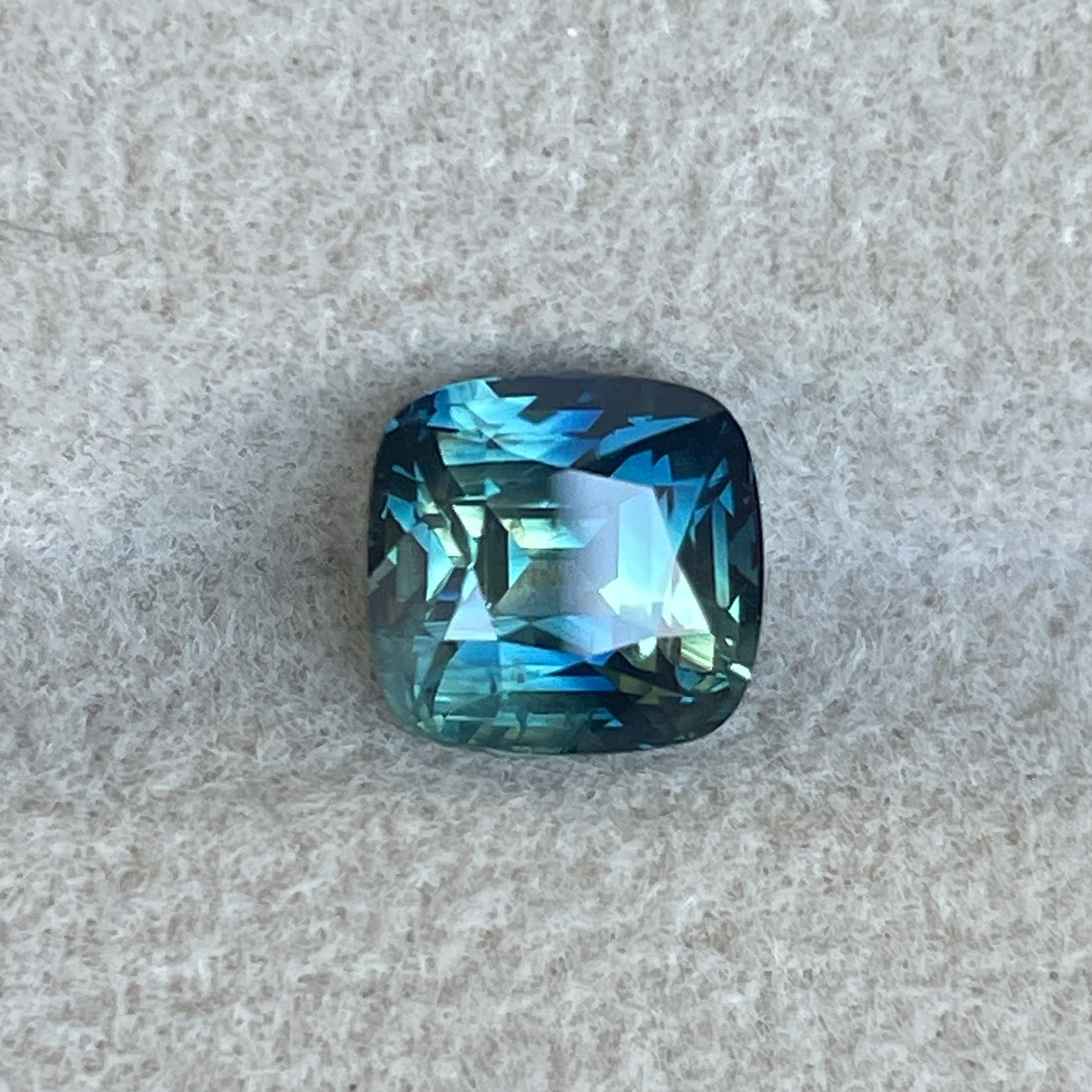Teal sapphire cushion cut 2.14 Ct from NASHGEMS, natural blue-green loose sapphire for engagement rings or custom jewelry.