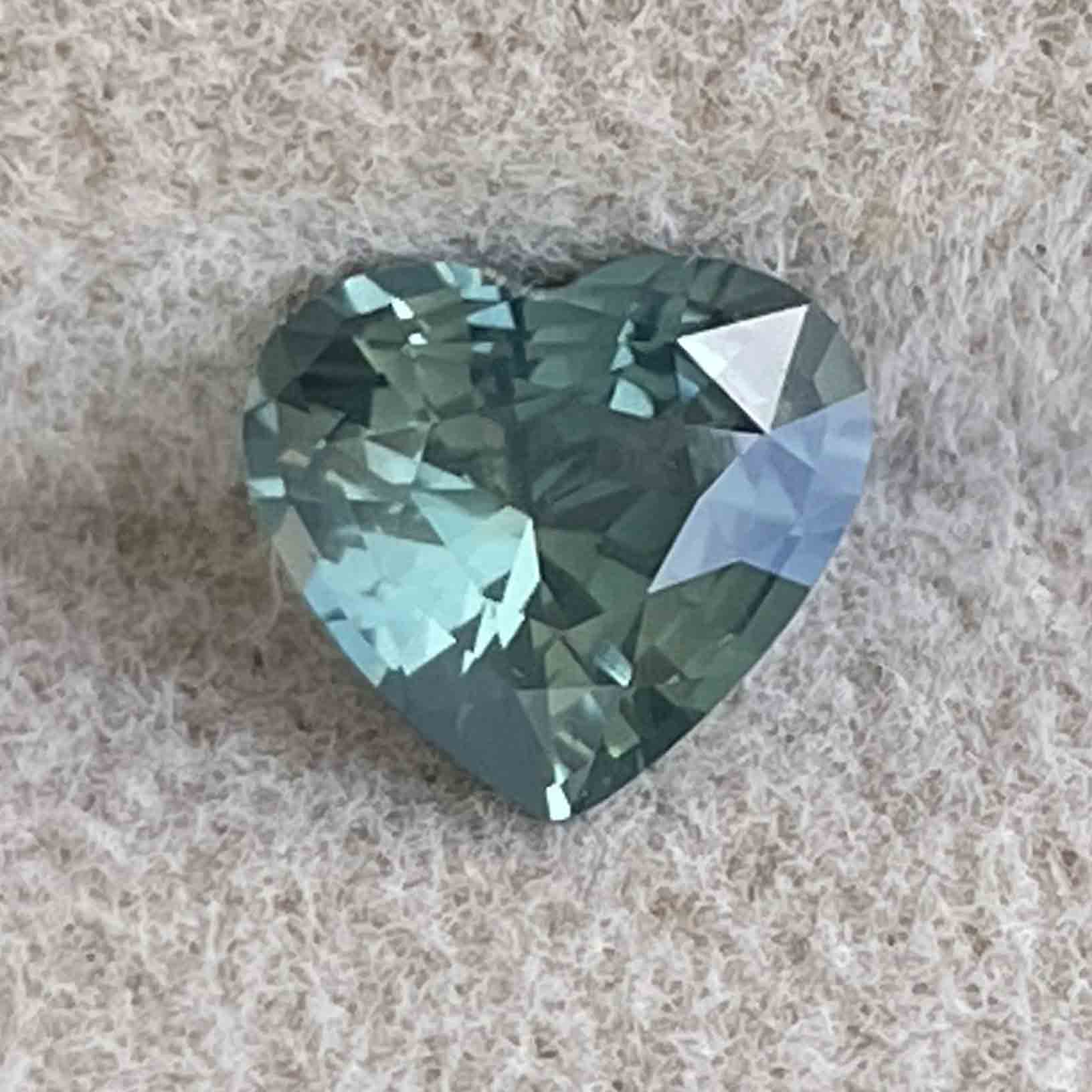 Teal green sapphire heart-shaped loose gemstone, 1.12 carats, heat-treated NASHGEMS sapphire for engagement or custom jewelry.