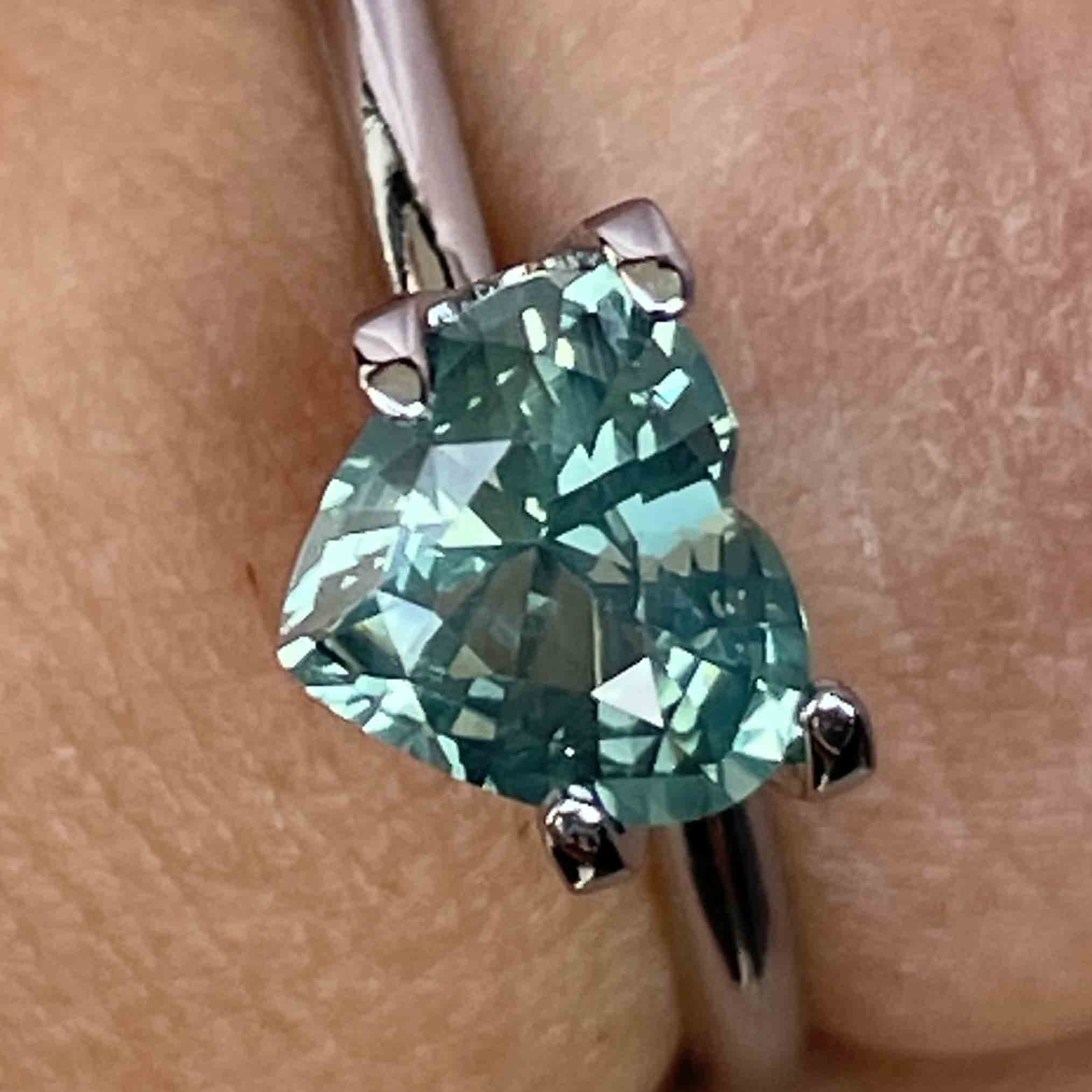 Loose teal green sapphire heart-shaped 1.12ct by NASHGEMS, heat-treated gemstone for engagement or custom jewelry.