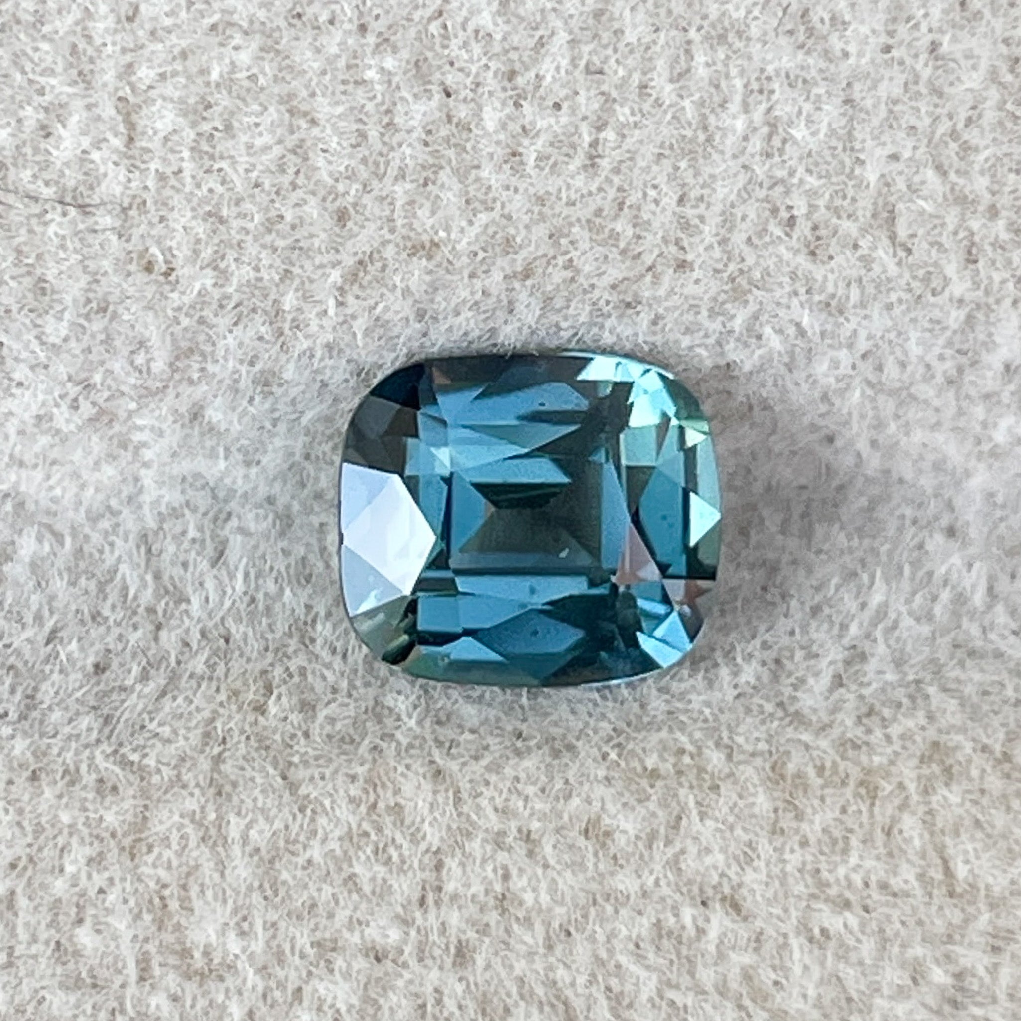 Natural teal blue sapphire 1.18 ct cushion cut loose gemstone by NASHGEMS, perfect for engagement rings or custom jewelry.