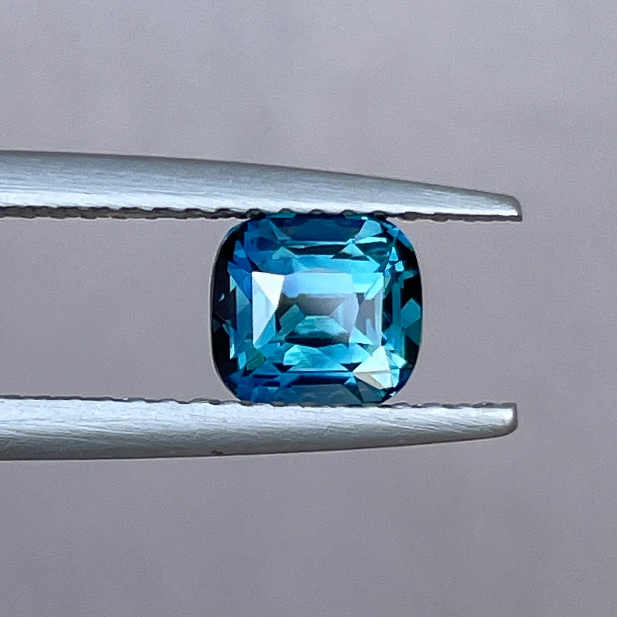 Natural teal blue sapphire 1.52 ct cushion cut loose gemstone by NASHGEMS, ideal for engagement rings or custom jewelry.