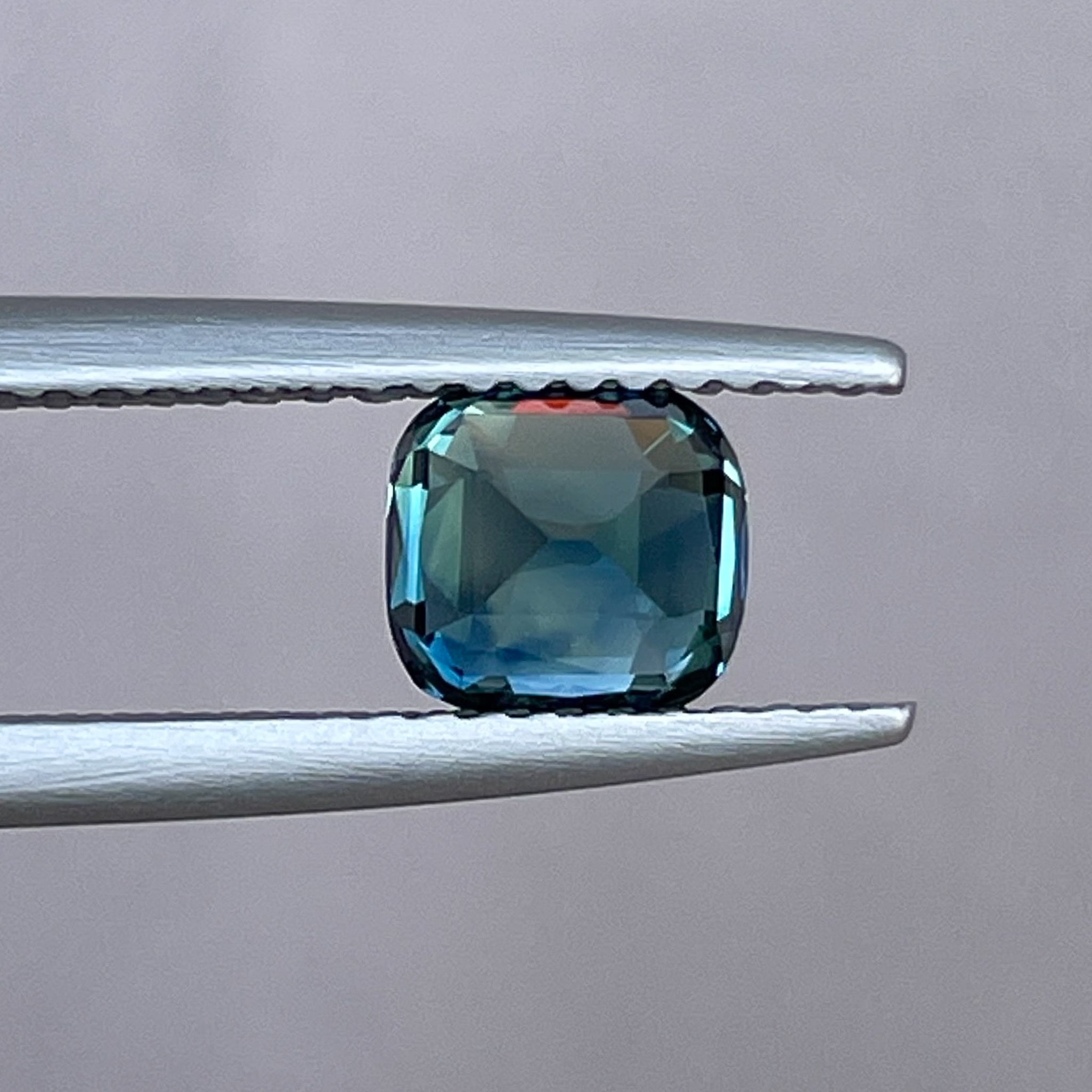 Teal blue sapphire loose cushion cut gemstone, 1.52 carats, natural no heat sapphire for engagement rings or custom jewelry.