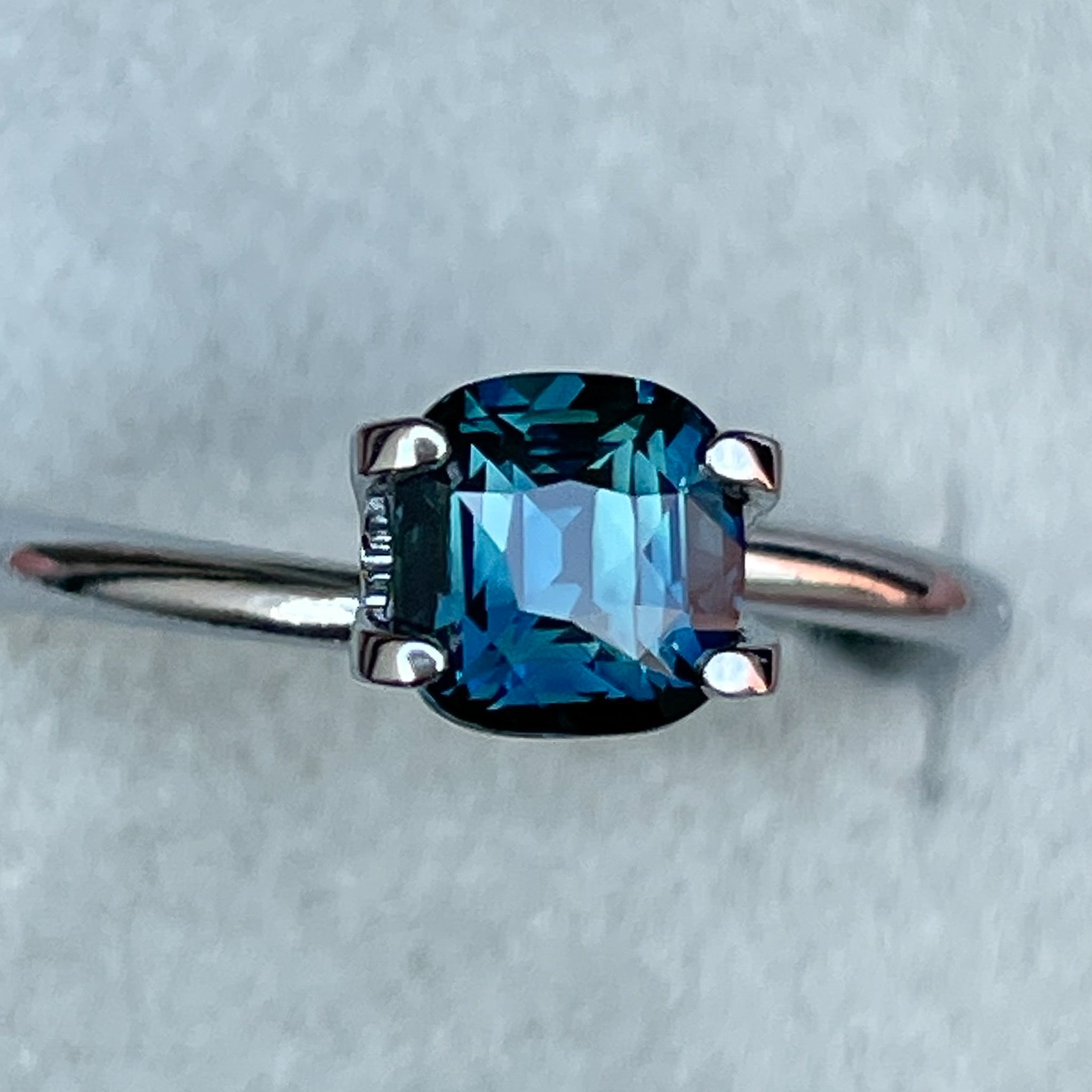 Natural teal blue sapphire 1.52 Ct cushion cut loose gemstone by NASHGEMS, ideal for engagement rings or custom jewelry.