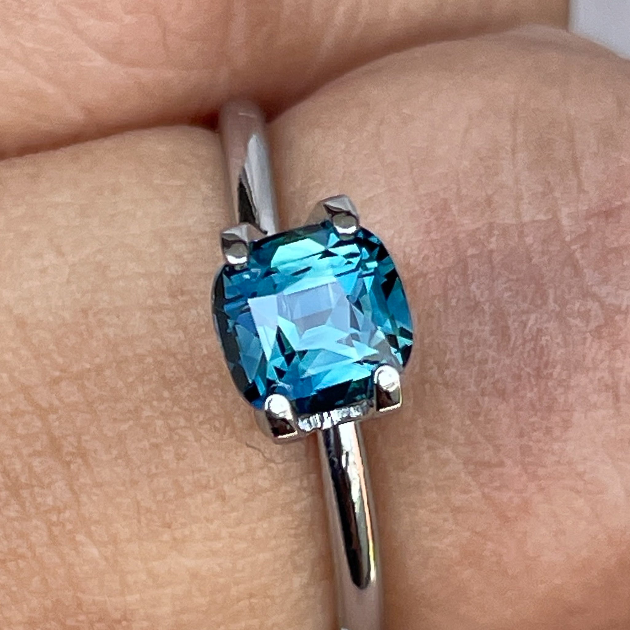 Natural teal blue sapphire, 1.52 ct cushion cut loose gemstone by NASHGEMS, perfect for engagement rings or custom jewelry.