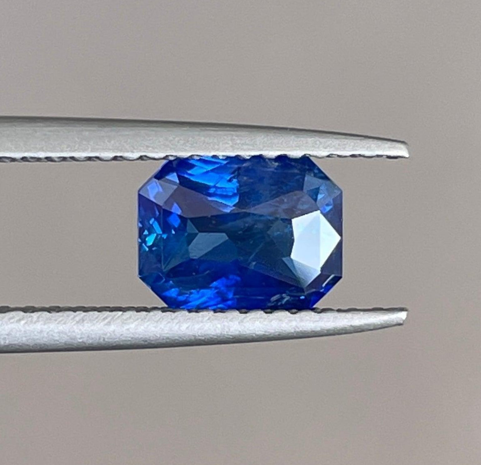 Natural blue sapphire gemstone from NASHGEMS, 1.51 carats, set in an engagement ring, showcasing its vibrant blue color and clarity.