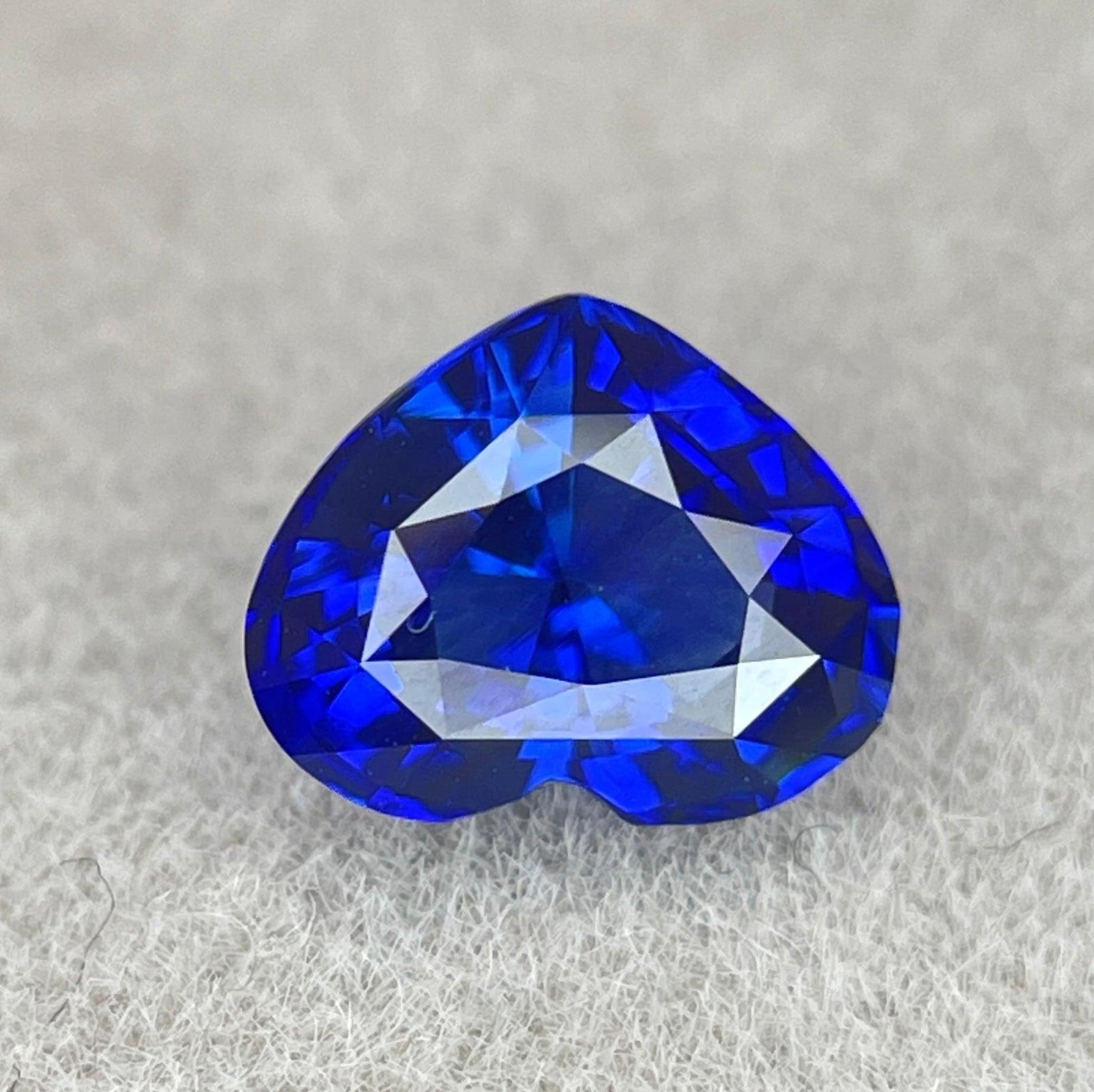 Genuine 1.04 ct blue sapphire from Sri Lanka in a royal blue color, paired with a matching wedding band, from NASHGEMS.