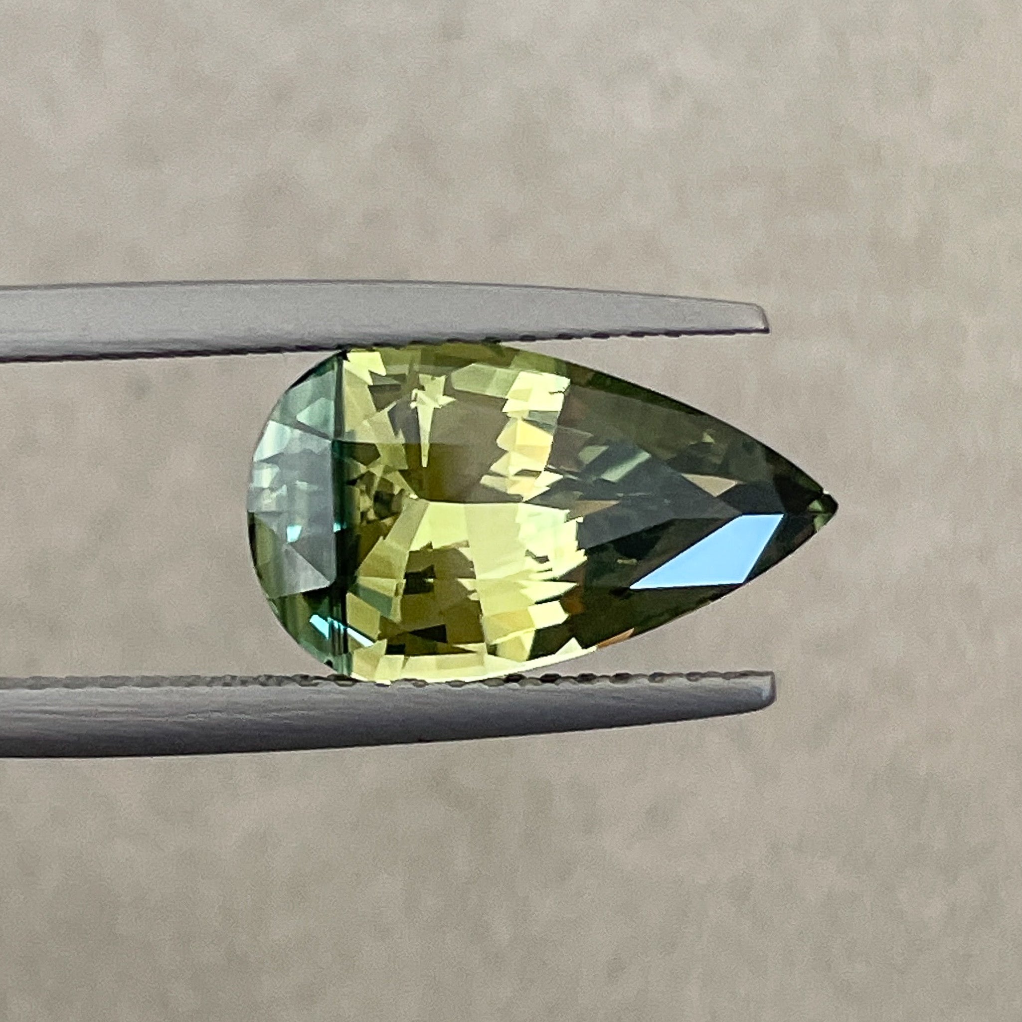 Teal parti sapphire, 5.02 ct pear shape, no heat, bi-color loose sapphire from NASHGEMS for engagement jewelry.
