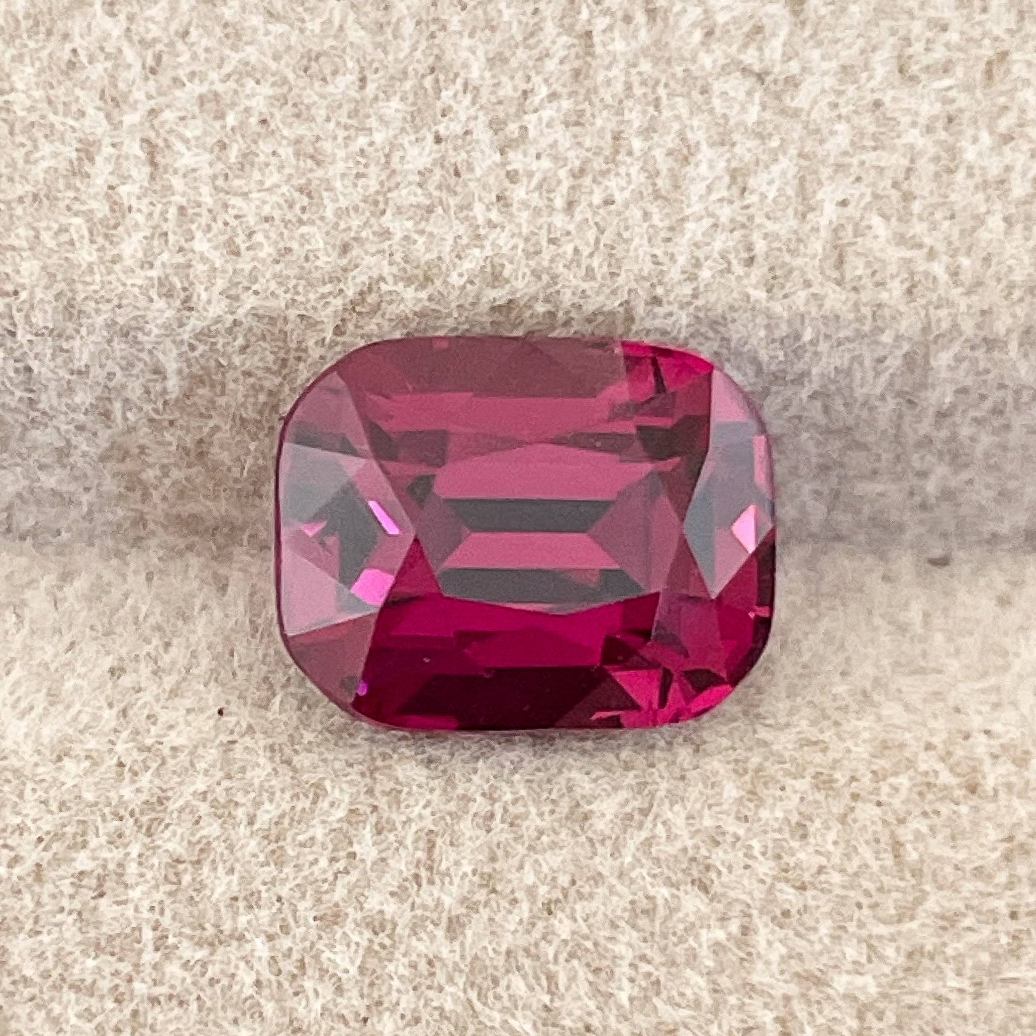 Natural Rhodolite Garnet 3.39 Ct cushion cut gemstone with raspberry red color, VVS clarity, suitable for engagement rings.