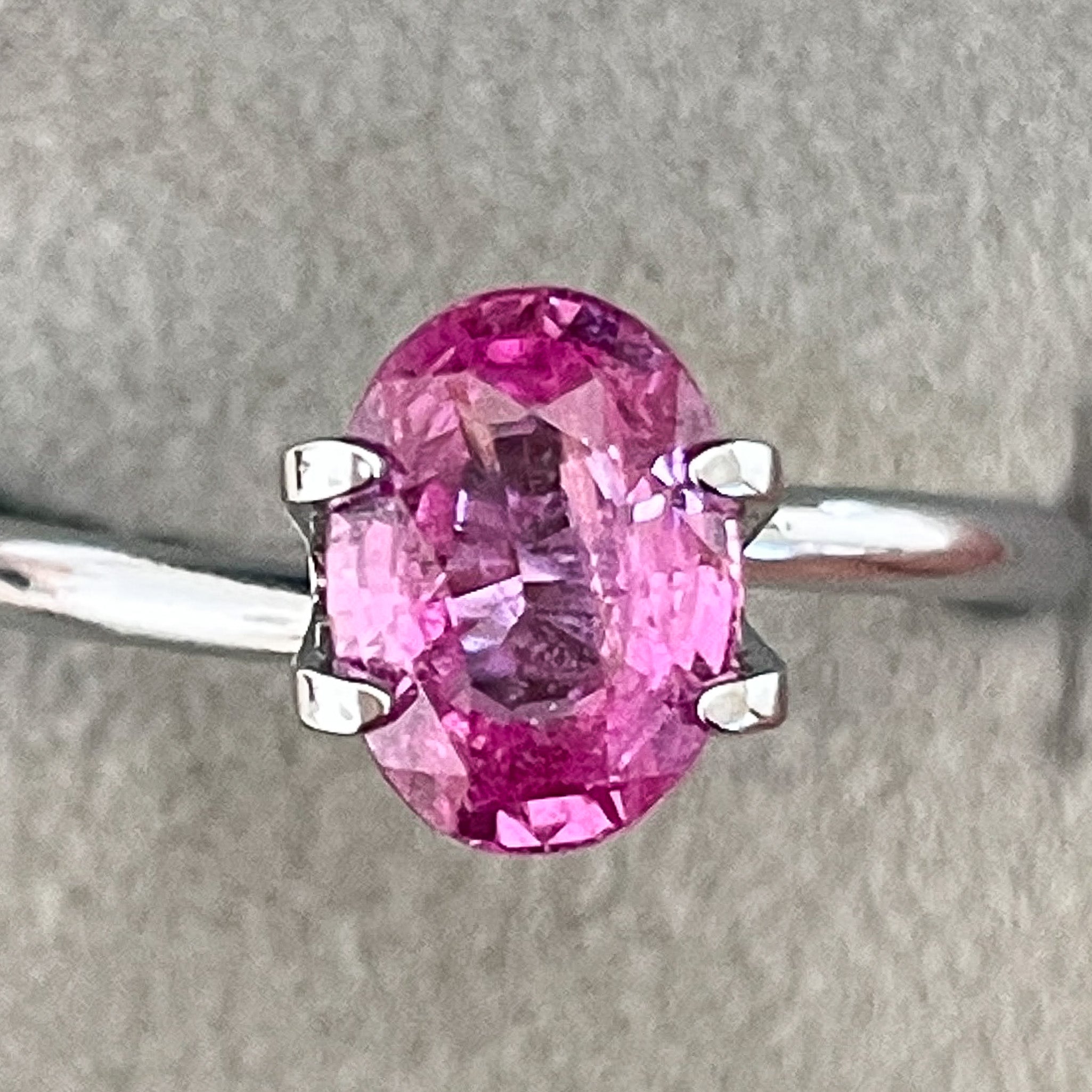 Natural pink sapphire loose gemstone, 1.65 Ct oval cut by NASHGEMS, ideal for engagement rings or jewelry designs.