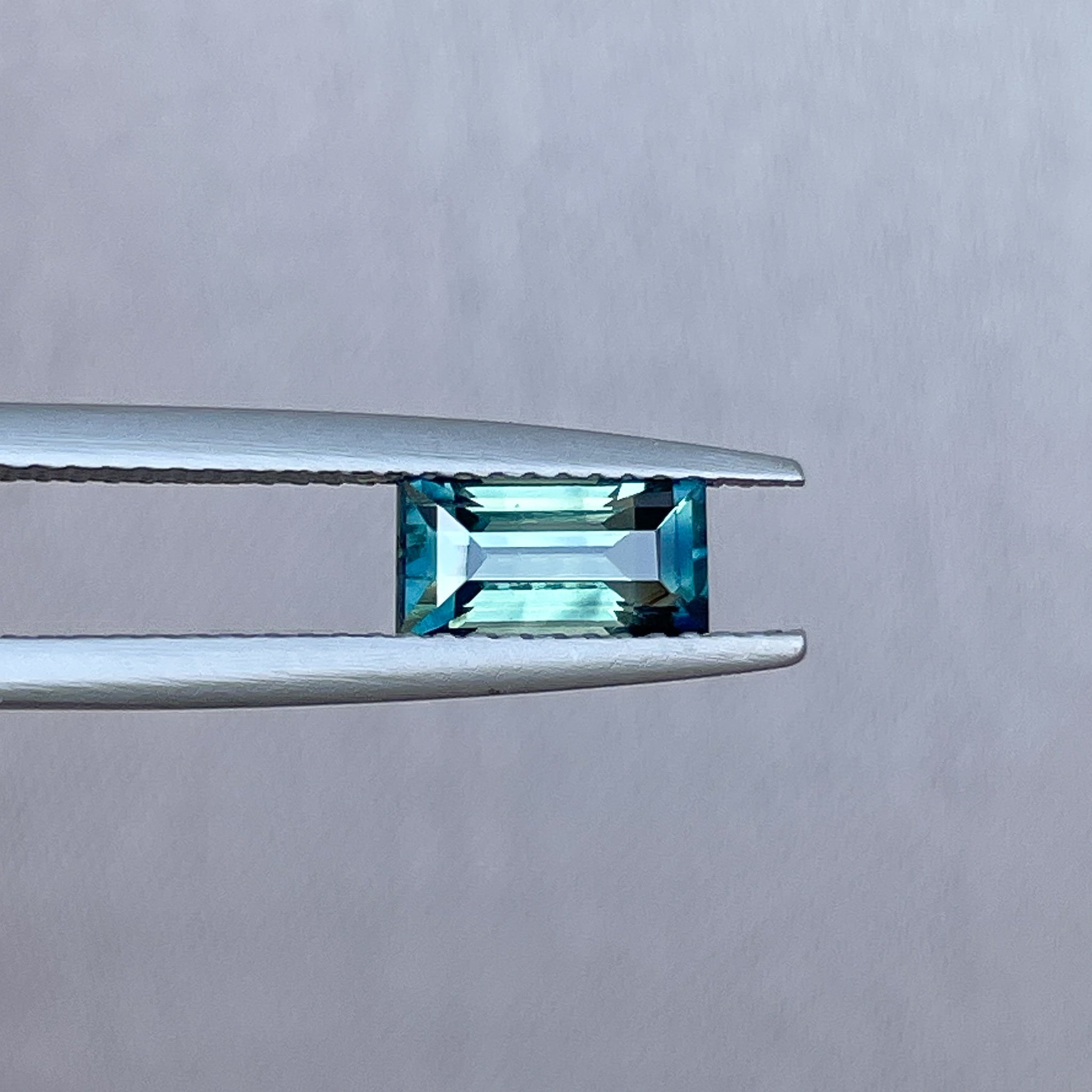 Teal sapphire 1.30 Crt bicolor princess cut gemstone from NASHGEMS, perfect for custom engagement rings or green gemstone jewelry.