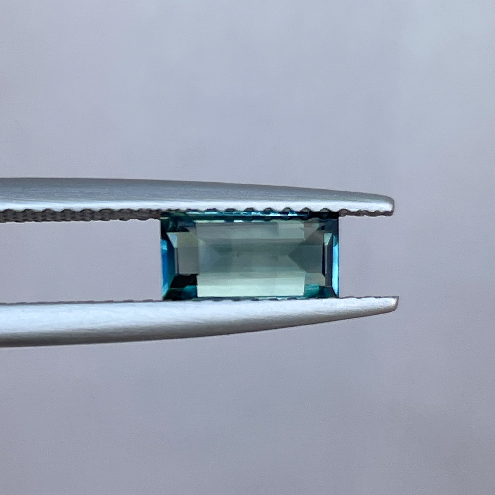 Teal sapphire 1.30 carat bicolour princess cut gemstone from NASHGEMS, perfect for engagement rings or green jewelry necklaces.