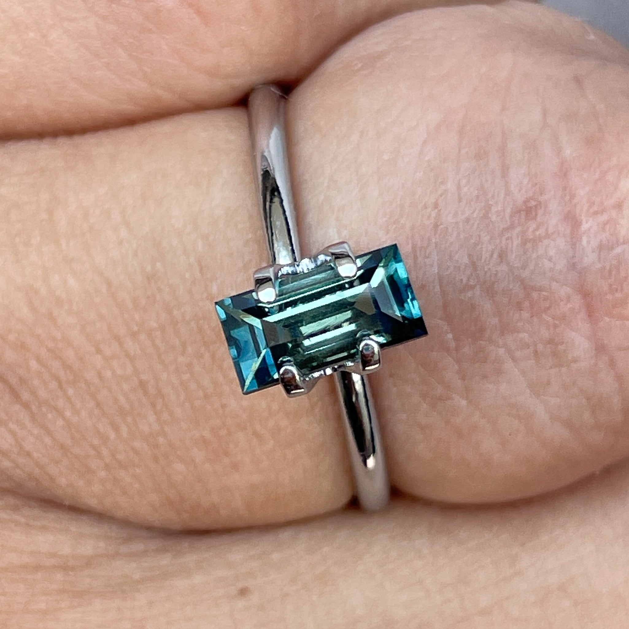 Teal sapphire 1.30 carat bicolour princess cut precious stone, ideal for custom engagement rings and jewelry from NASHGEMS.
