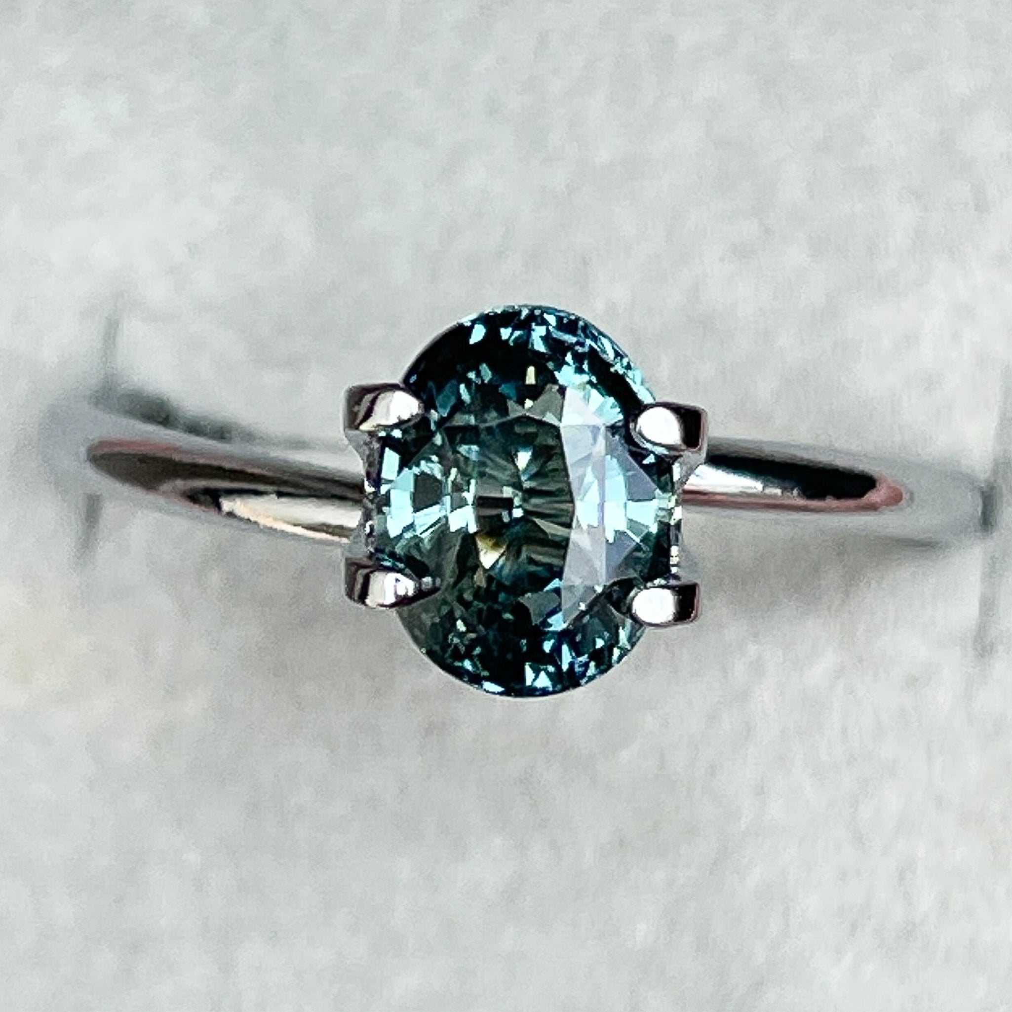 Natural teal blue-green sapphire, 2.03 Ct oval cut loose gemstone from NASHGEMS, ideal for engagement rings or custom jewelry.