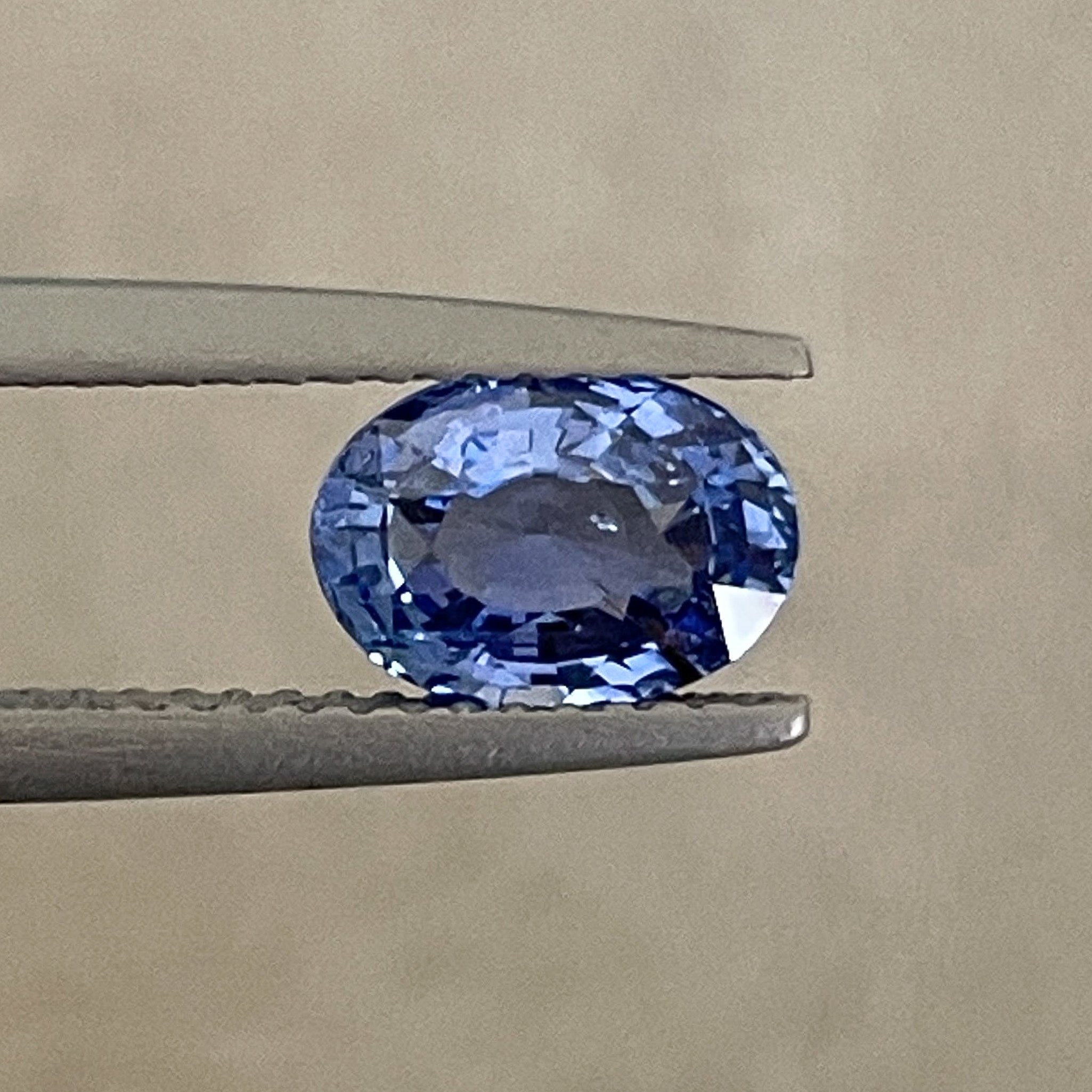 Natural Ceylon Blue Sapphire 1.54 Ct loose oval cut gemstone by NASHGEMS, showcasing vibrant blue color and polished surface.
