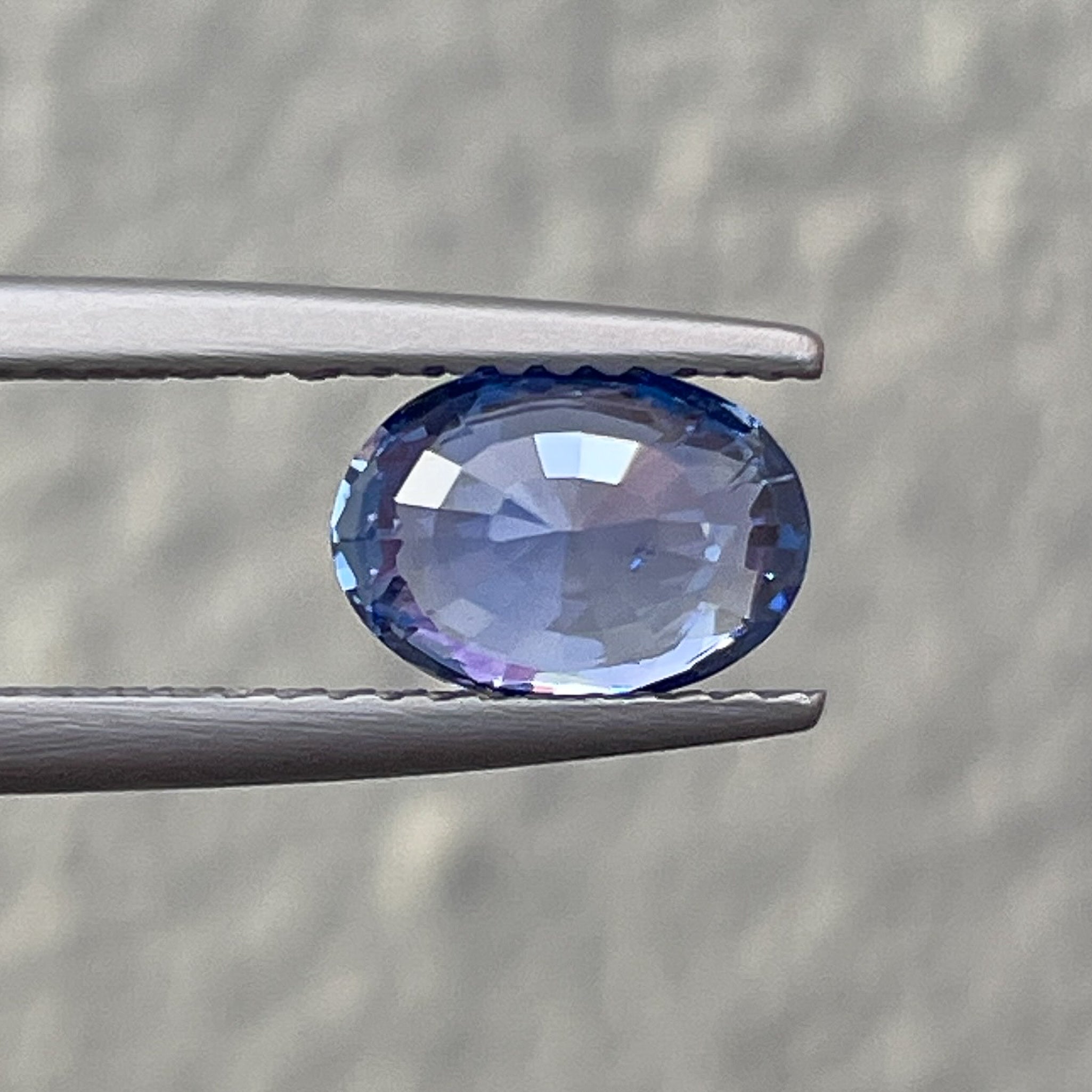 Natural Ceylon Blue Sapphire 1.54 Ct oval cut loose gemstone by NASHGEMS, showcasing the vibrant blue color and polished surface.