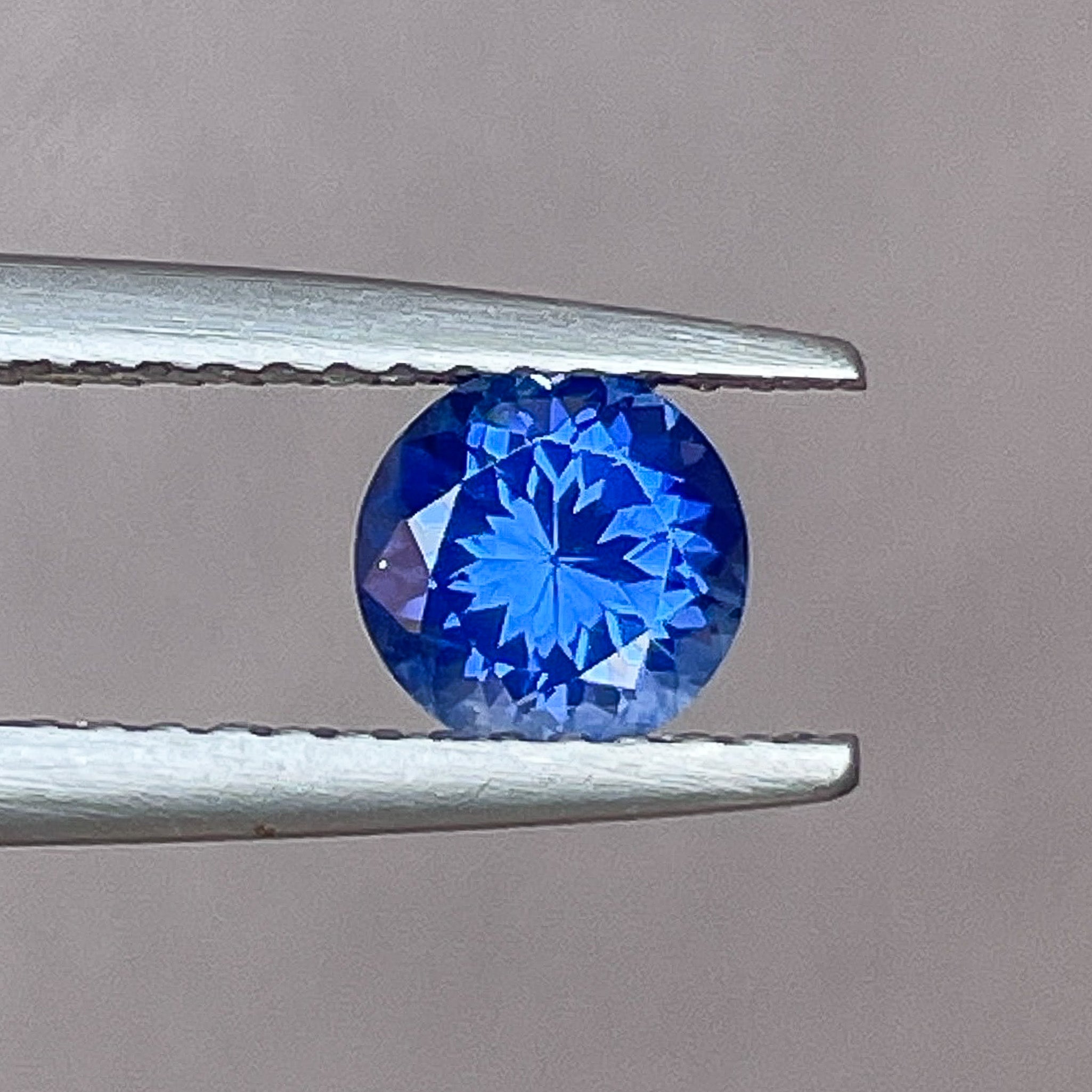 Natural Ceylon blue sapphire loose gemstone, round cut, 0.80 Ct, VVS clarity from NASHGEMS for engagement rings.