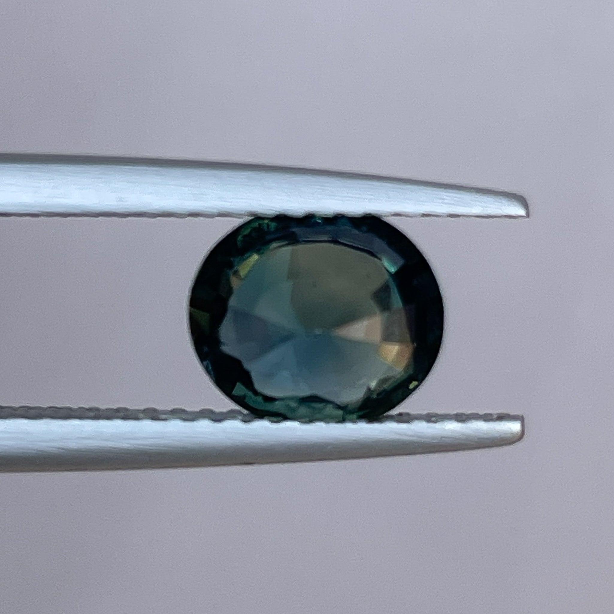Teal forest green sapphire loose gemstone, 1.56 Ct oval cut by NASHGEMS, suitable for engagement or custom jewelry.