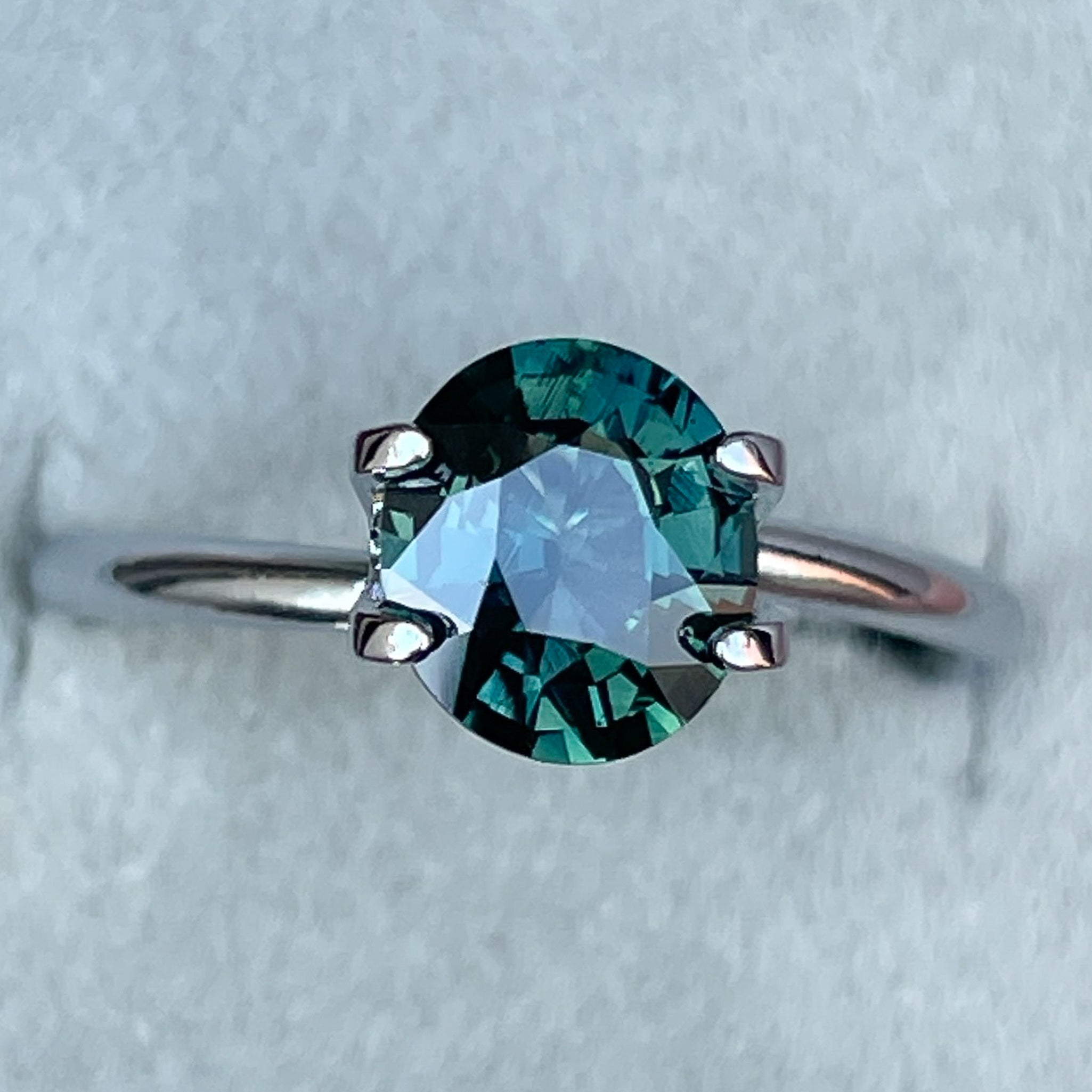 Natural forest green sapphire, 1.56 Ct oval cut teal loose gemstone by NASHGEMS, ideal for engagement rings or custom jewelry.