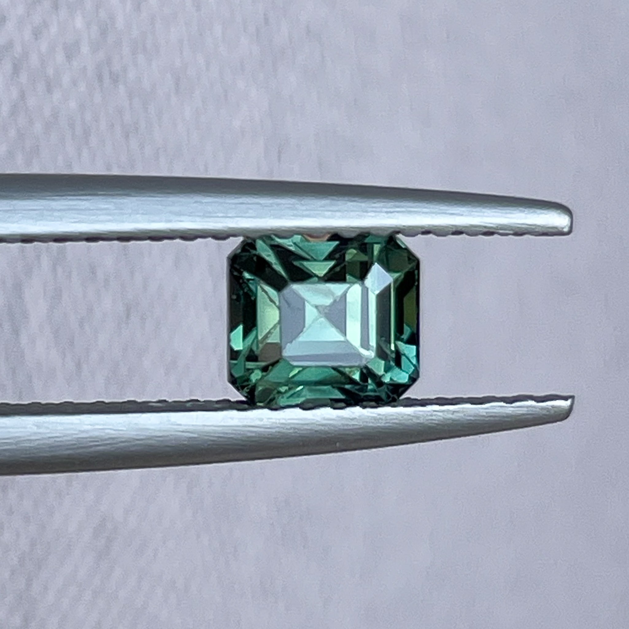 Natural forest green sapphire, 1.09 Ct emerald cut loose teal gemstone by NASHGEMS, ideal for engagement rings or custom jewelry.