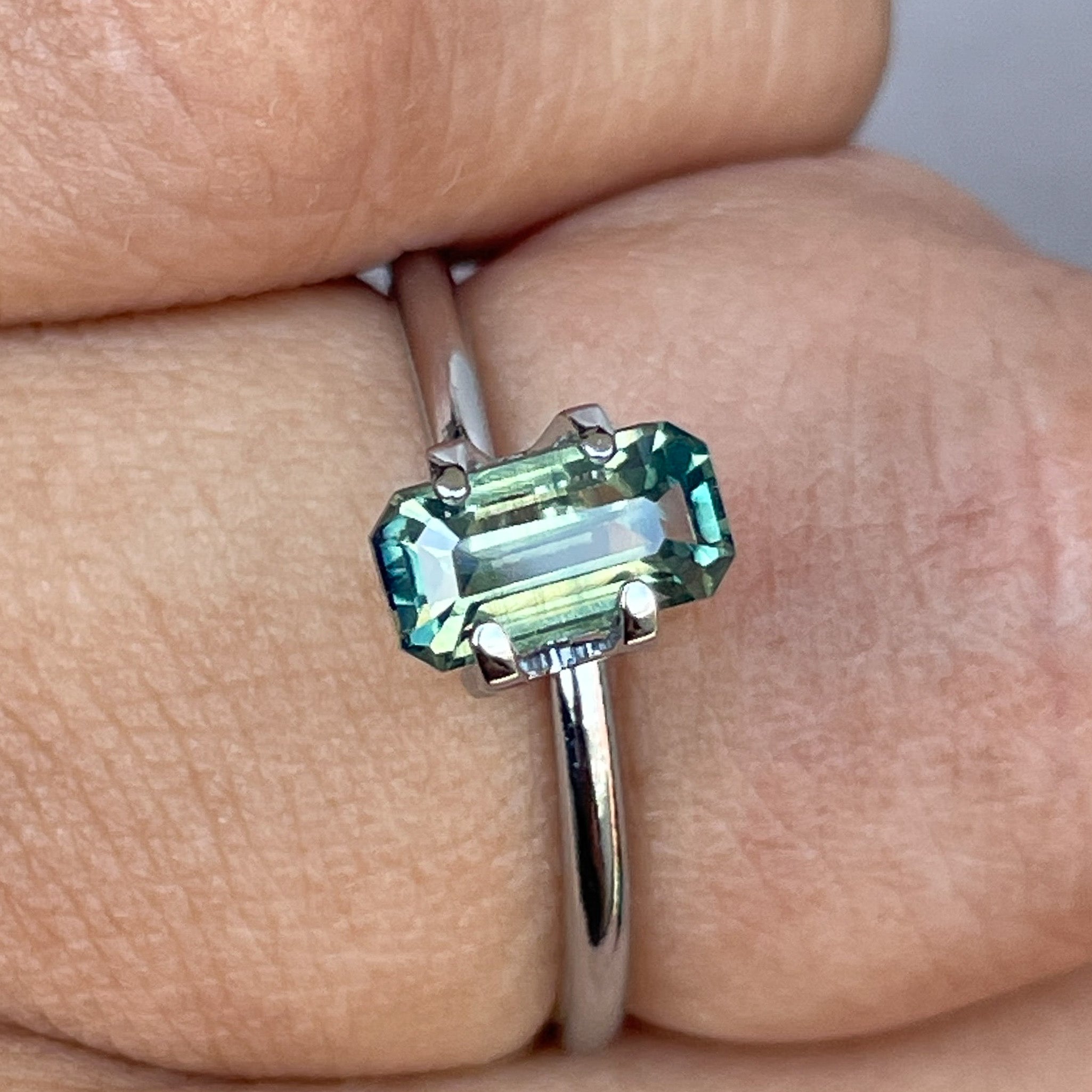 Teal sapphire loose gemstone, emerald cut, 1.49 carats, vibrant green color, from NASHGEMS, perfect for jewelry and September birthstone.
