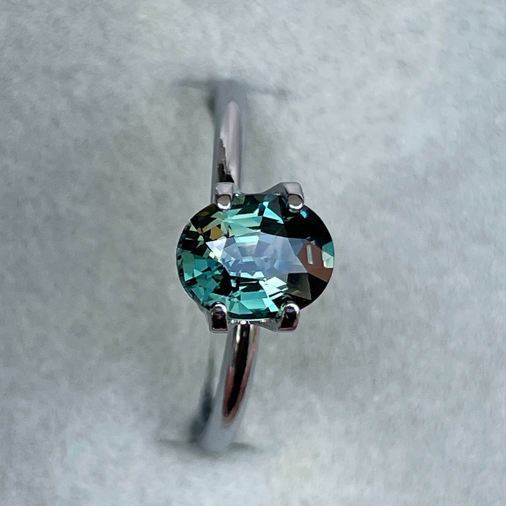 Teal green sapphire loose gemstone, 1.52 carats, oval cut, heat-treated sapphire for engagement or custom jewelry by NASHGEMS.