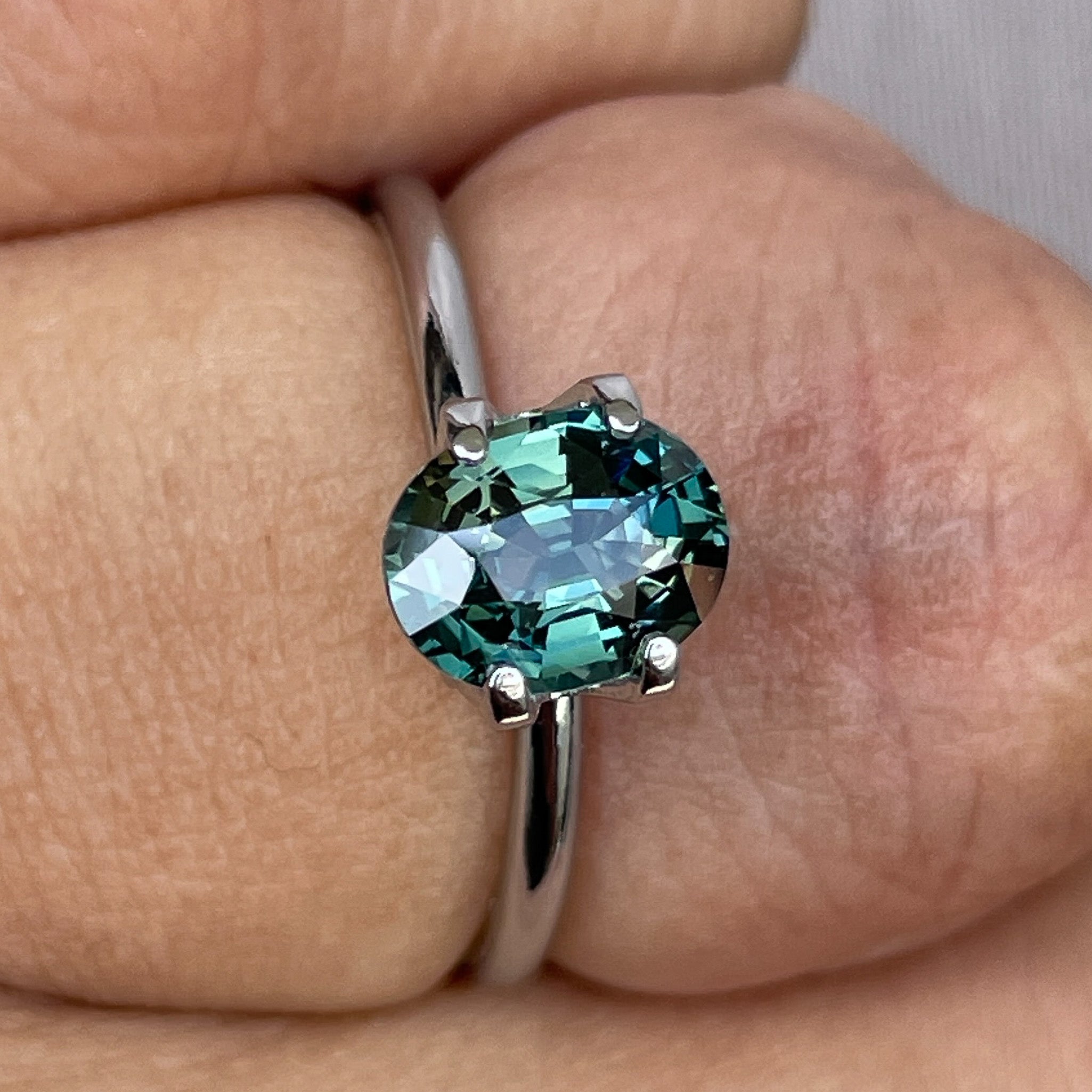 Natural teal green sapphire 1.52 Ct oval cut, heat-treated loose gemstone by NASHGEMS, ideal for engagement rings or custom jewelry.