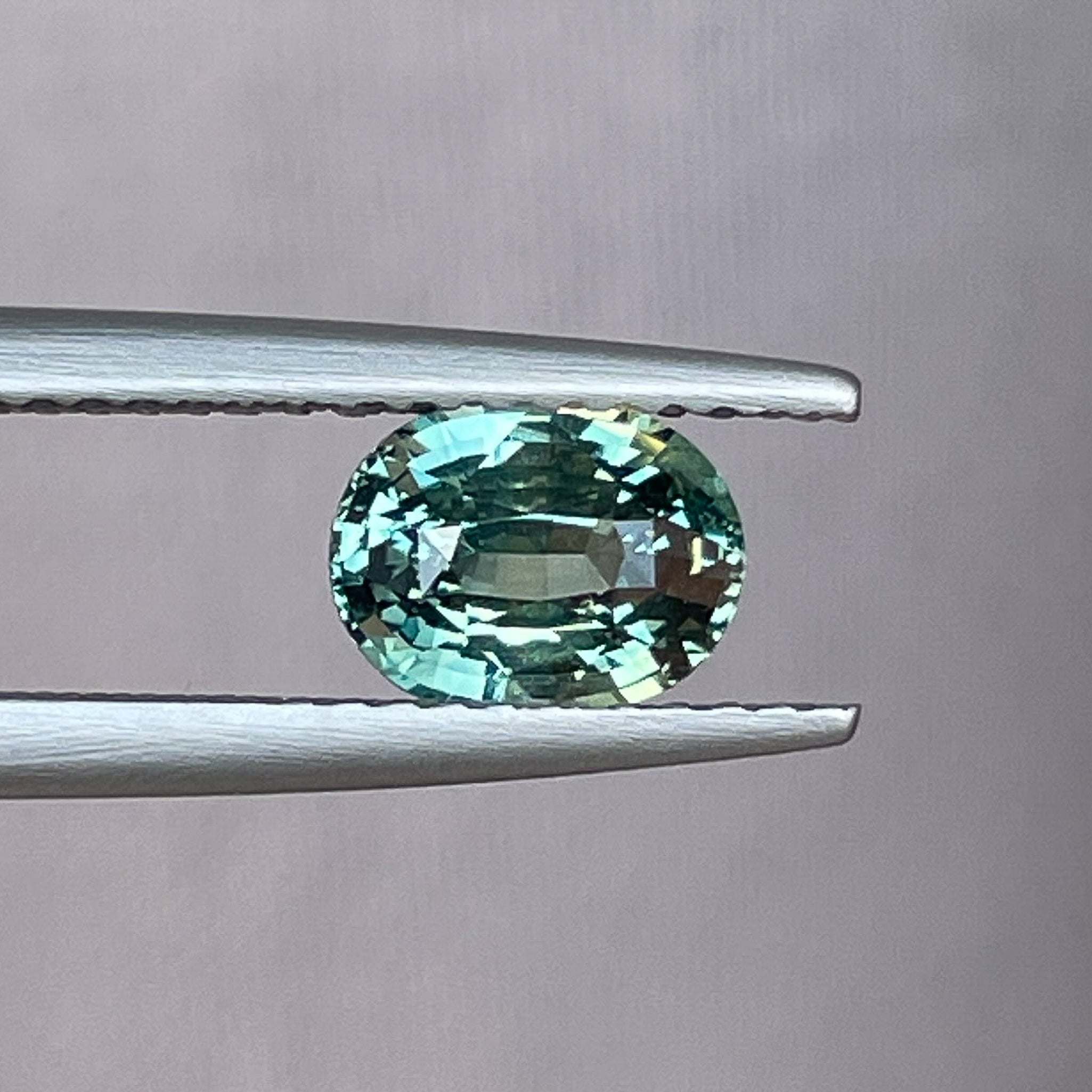 Natural teal green sapphire, 1.45 Ct oval cut loose gemstone by NASHGEMS, ideal for engagement rings or custom jewelry.