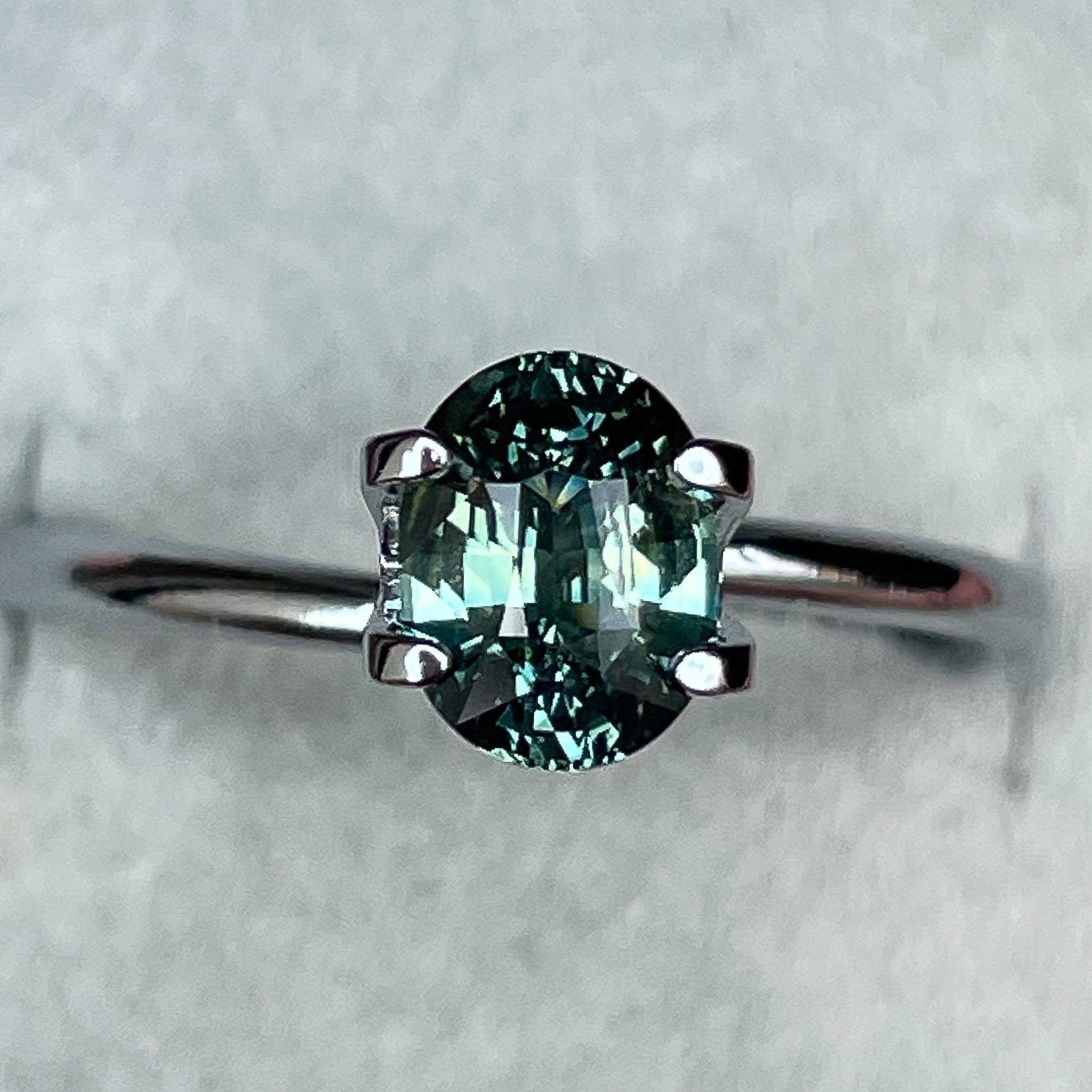 Natural teal green sapphire, 1.45 Ct oval cut loose gemstone by NASHGEMS, ideal for engagement rings or custom jewelry.