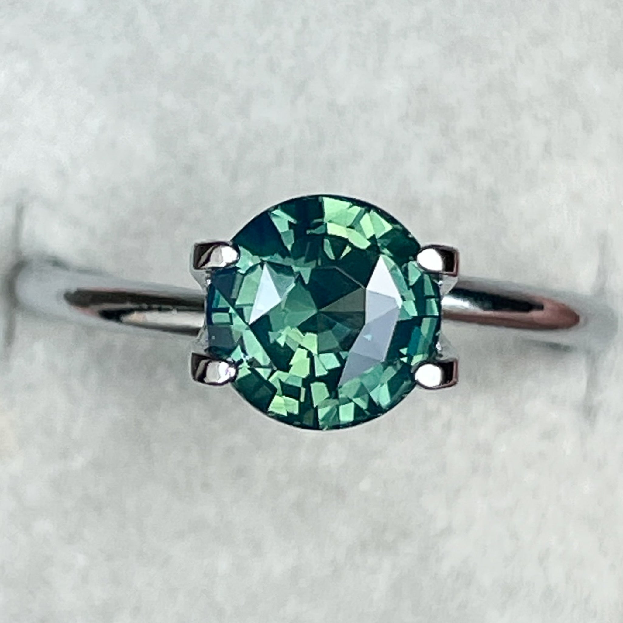 Natural forest green sapphire, 1.83 Ct round cut loose teal gemstone by NASHGEMS, suitable for engagement or custom jewelry.