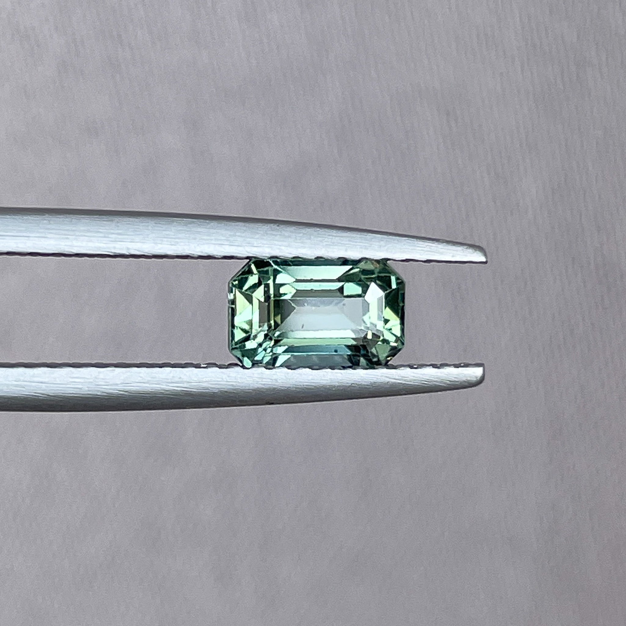 Natural pale green teal sapphire 1.24 Ct emerald cut by NASHGEMS, loose gemstone suitable for engagement rings or custom jewelry.