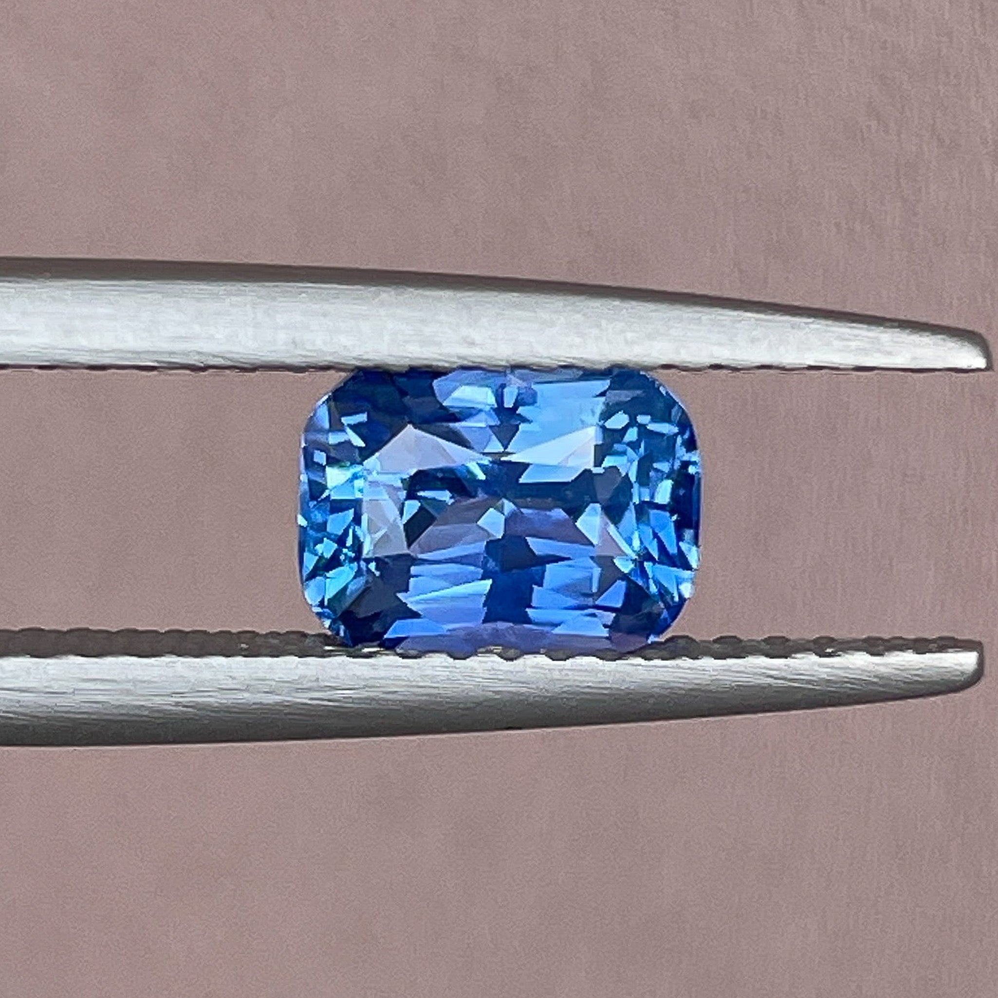 Natural Ceylon blue sapphire, 1.60 Ct cushion cut loose gemstone by NASHGEMS, vivid blue color ideal for jewelry or engagement rings.