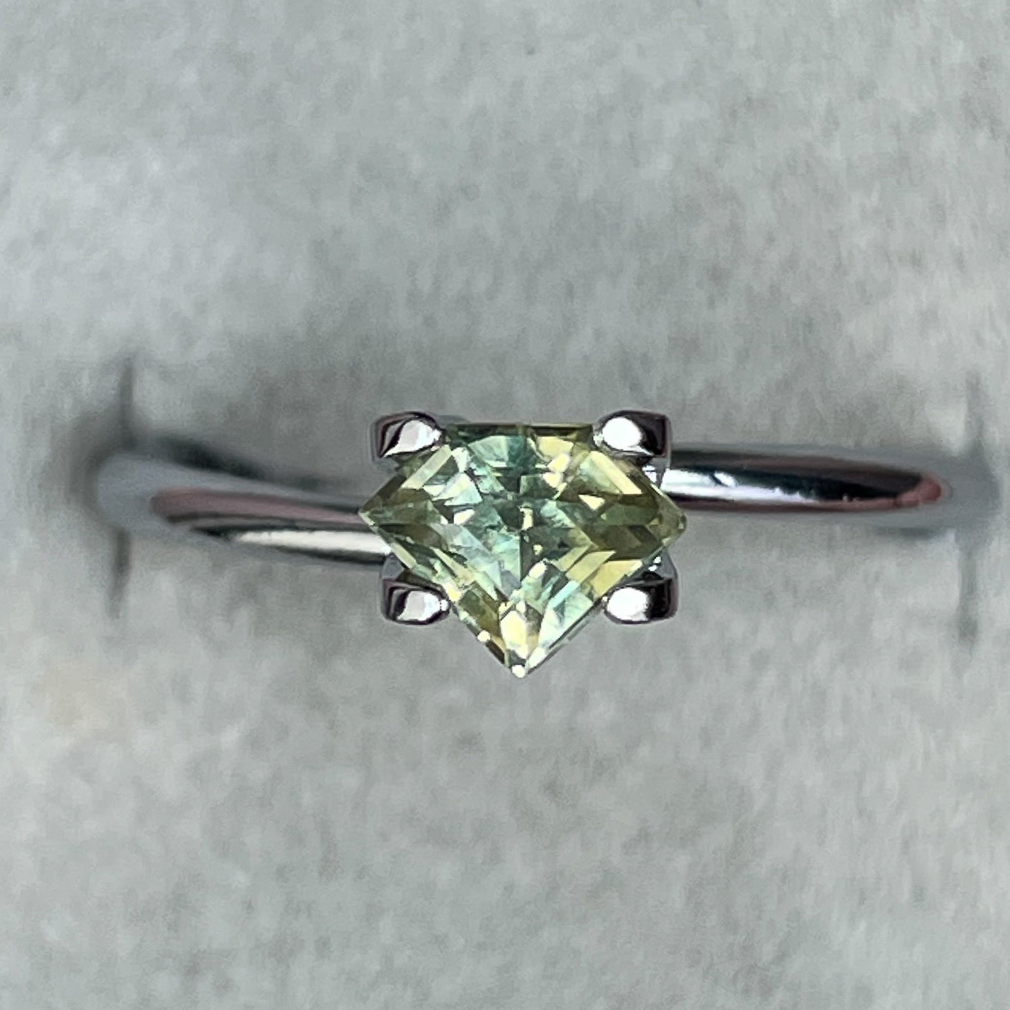 Natural pale green yellow sapphire, 0.72 Ct shield cut loose teal sapphire by NASHGEMS, ideal for engagement or custom jewelry.
