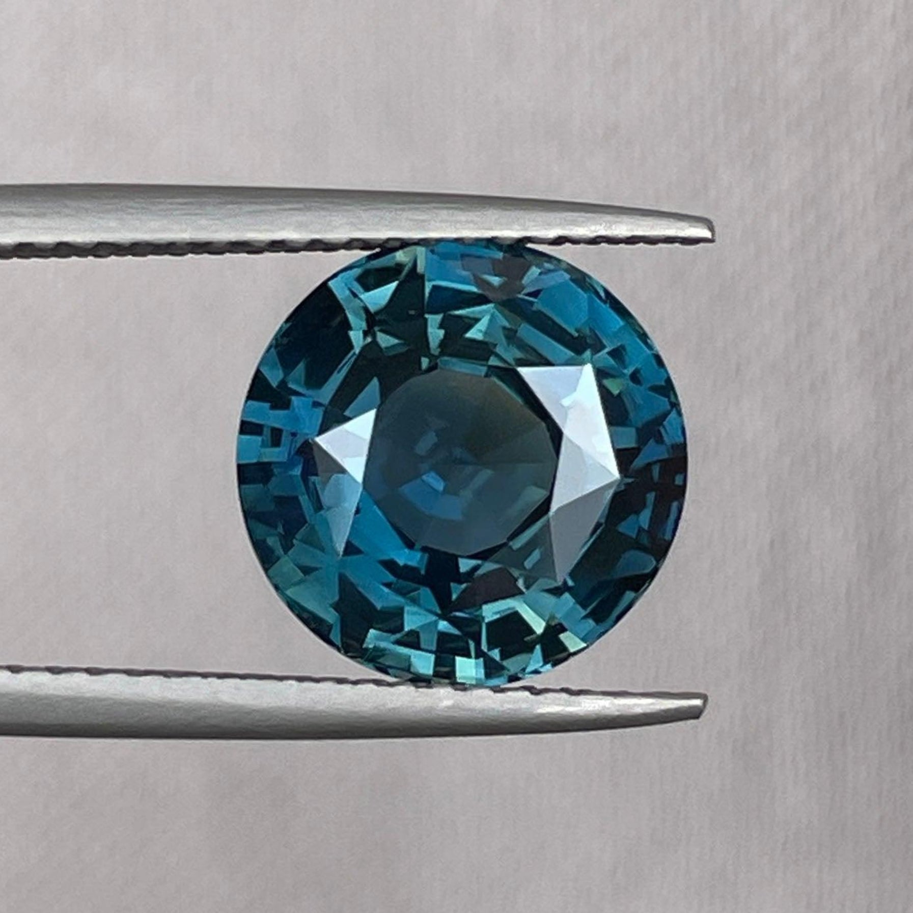 Teal sapphire round cut 5.52 carat gemstone from NASHGEMS, ideal for anniversary rings or pendant jewelry for women.