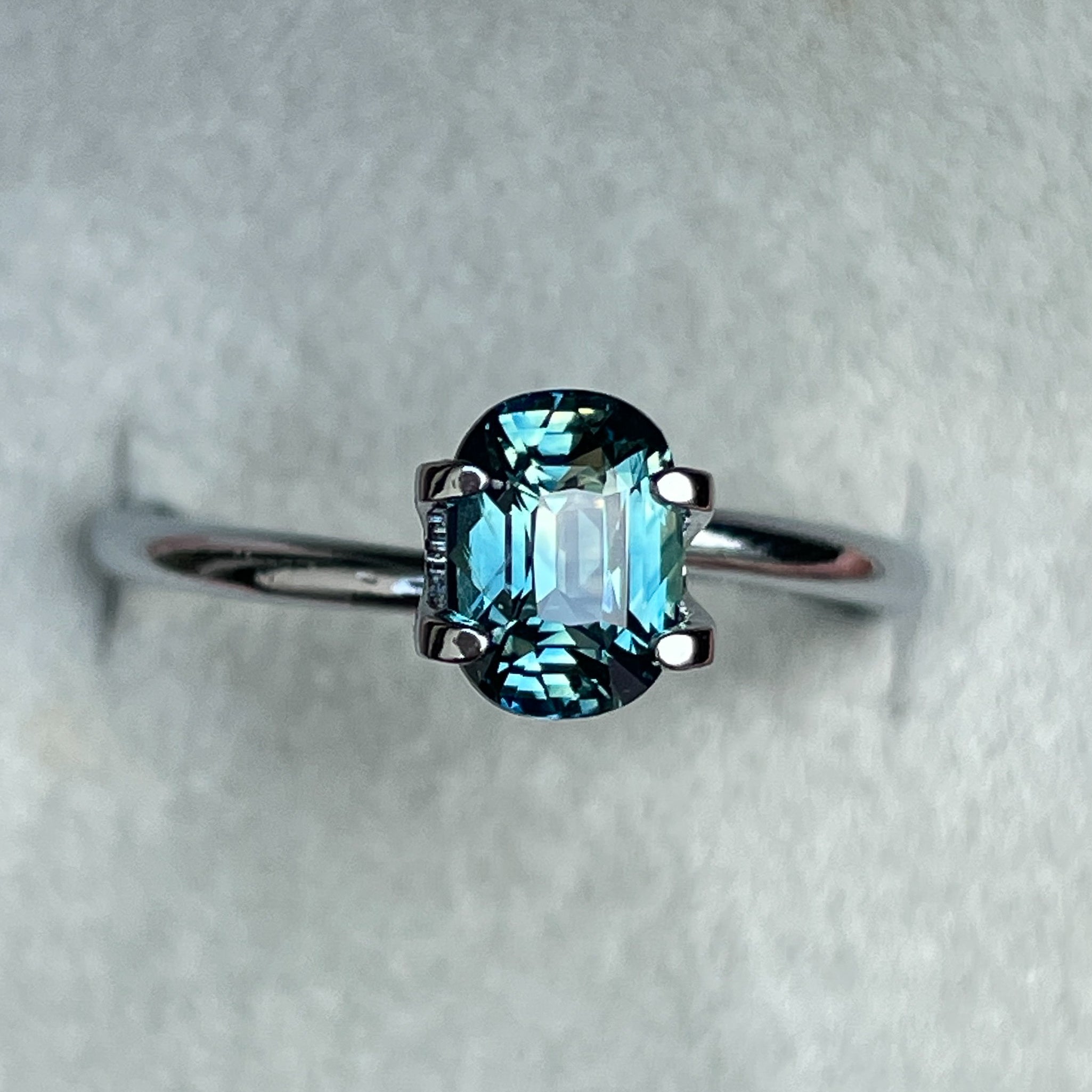 Natural teal sapphire 1.36 ct cushion cut by NASHGEMS, vibrant blue-green loose gemstone for engagement or custom jewelry.