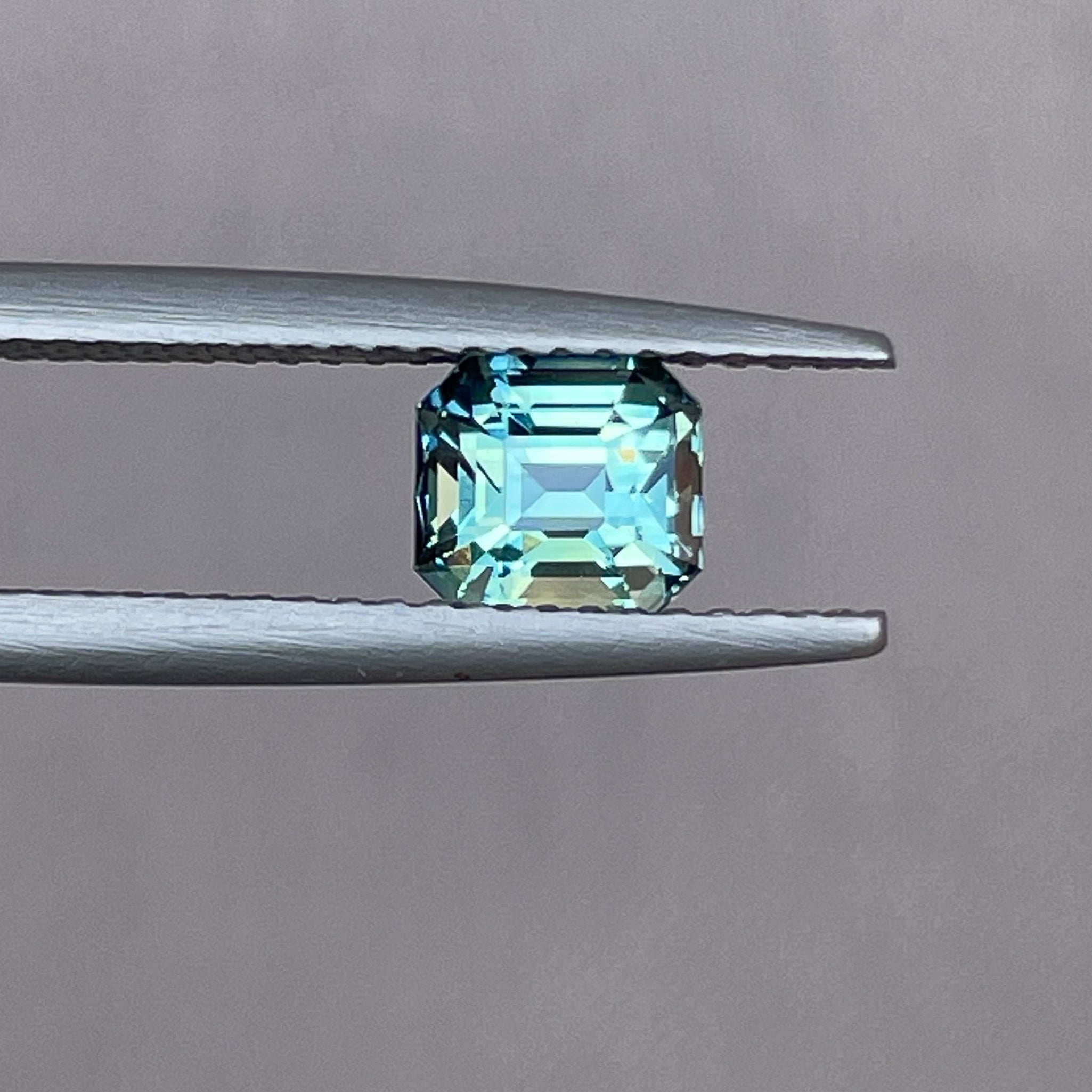 Natural teal green sapphire 1.36 Ct emerald cut by NASHGEMS, showcasing vibrant blue-green gemstone for jewelry or engagement rings.