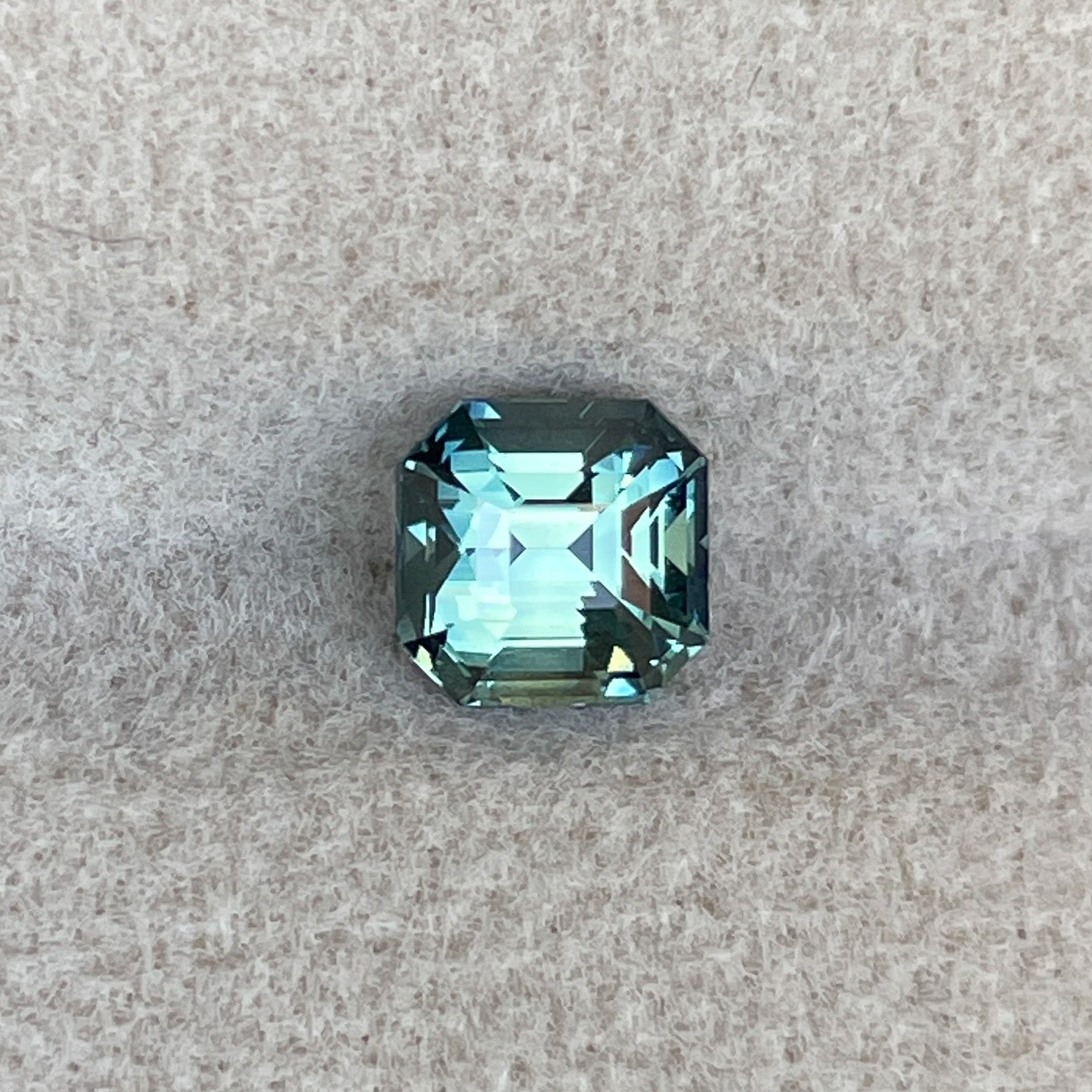 Teal green sapphire 1.36 Ct emerald cut, loose gemstone by NASHGEMS, ideal for engagement rings or custom jewelry.