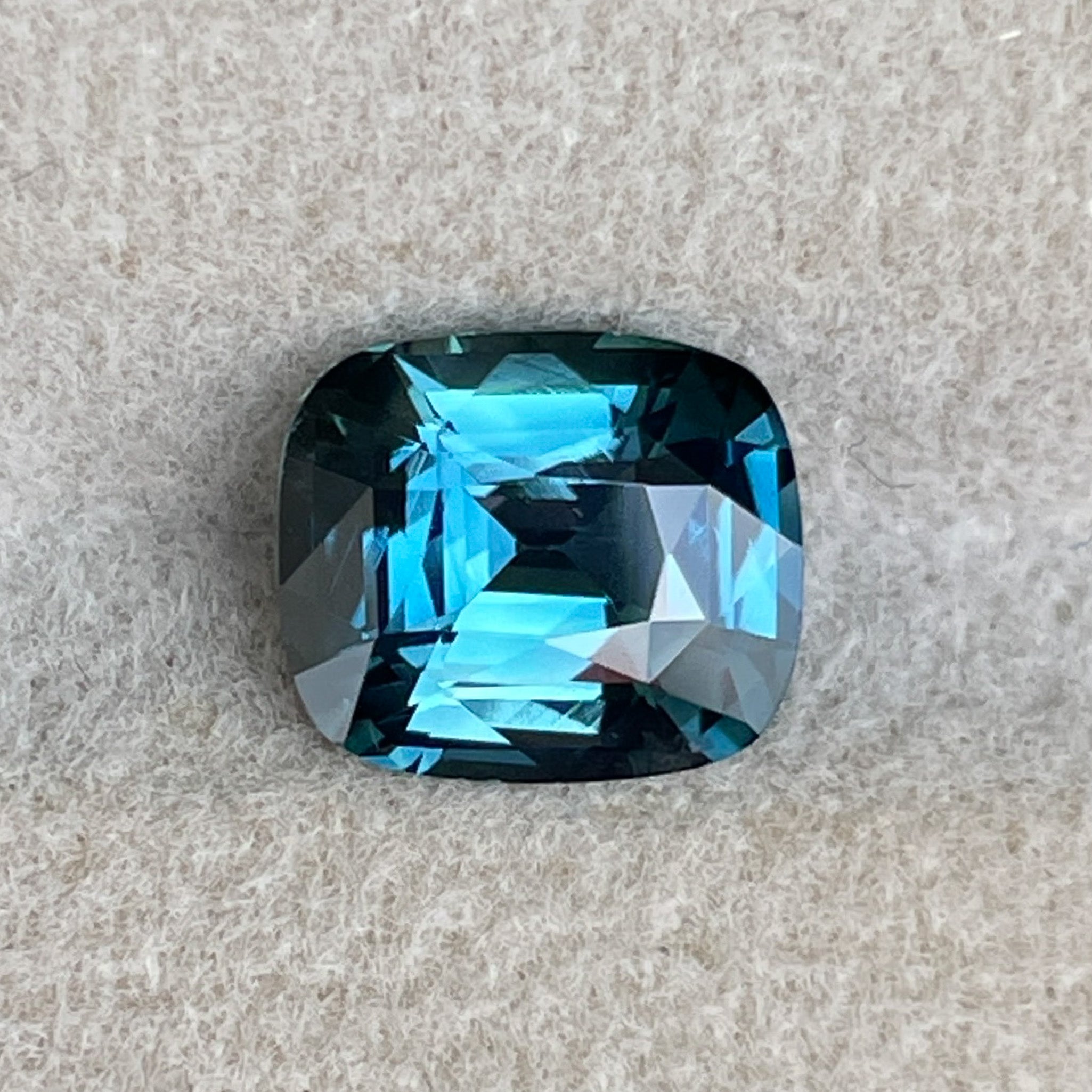 Natural teal blue sapphire loose gemstone, 2.52 ct cushion cut, heat treated, ideal for engagement rings or custom jewelry.