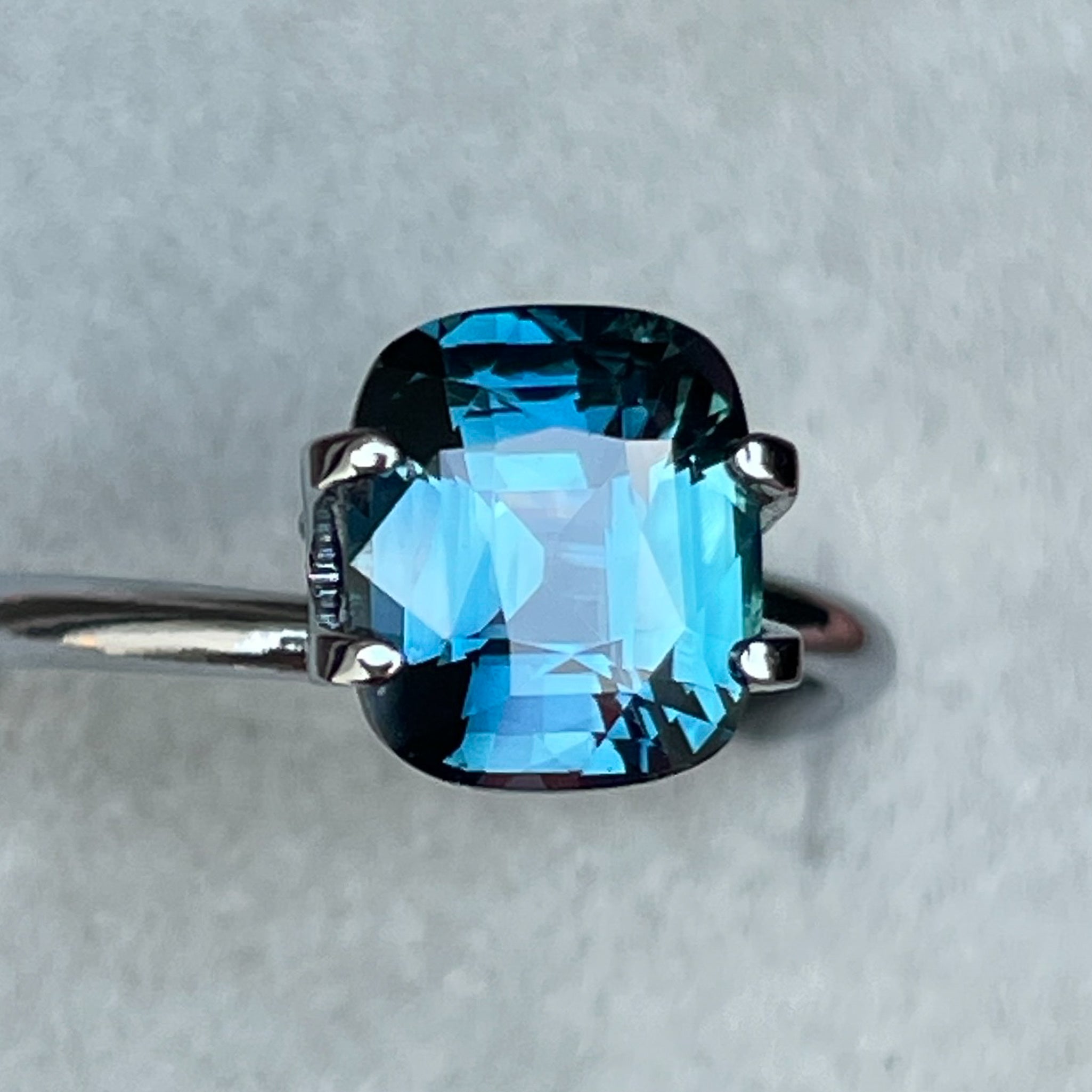 Teal blue sapphire loose cushion cut 2.52 carats from NASHGEMS, showcasing vibrant teal and green hues for jewelry design.