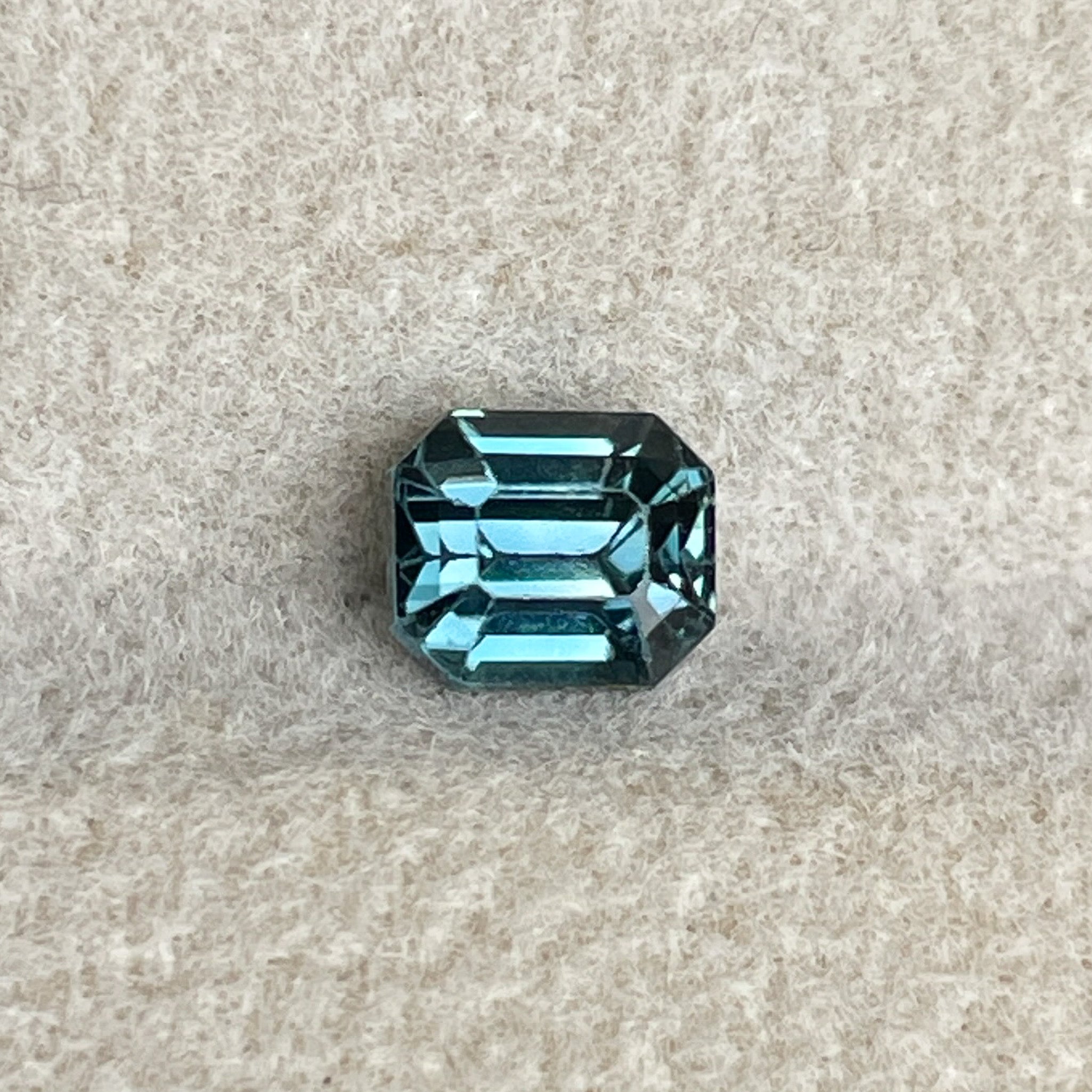 Natural teal blue sapphire 1.00 Ct emerald cut loose stone from NASHGEMS, ideal for engagement rings or custom jewelry.