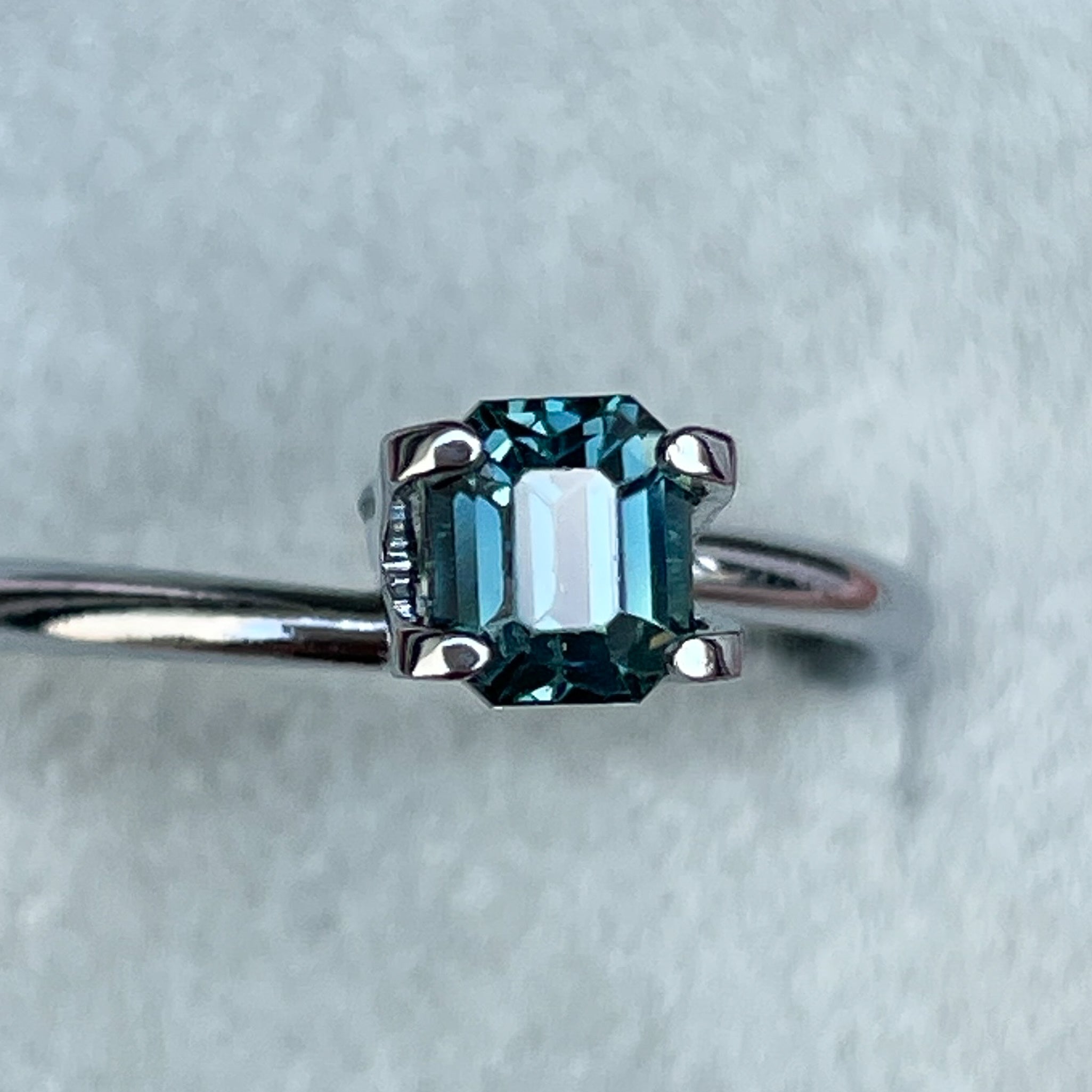Natural teal blue sapphire 1.00 ct emerald cut loose gemstone from NASHGEMS, ideal for engagement rings or custom jewelry.