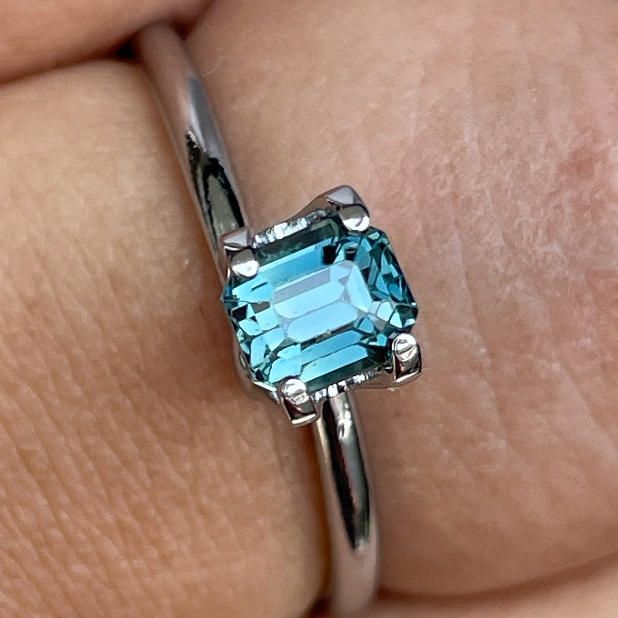 Natural teal blue sapphire 1.00 Ct emerald cut loose stone from NASHGEMS, ideal for engagement rings or custom jewelry designs.