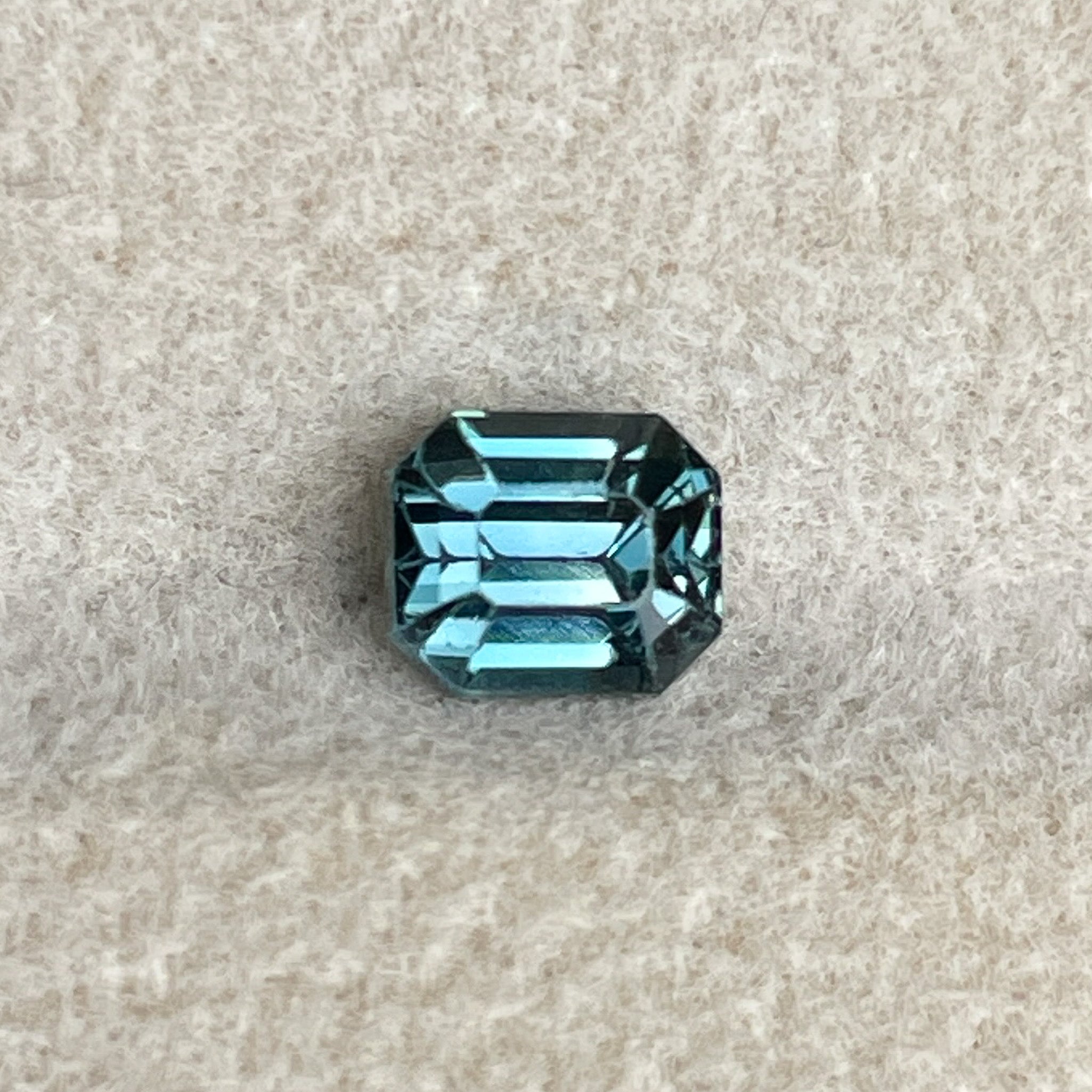 Natural teal blue sapphire 1.00 Ct emerald cut loose gemstone by NASHGEMS, ideal for engagement rings or custom jewelry.
