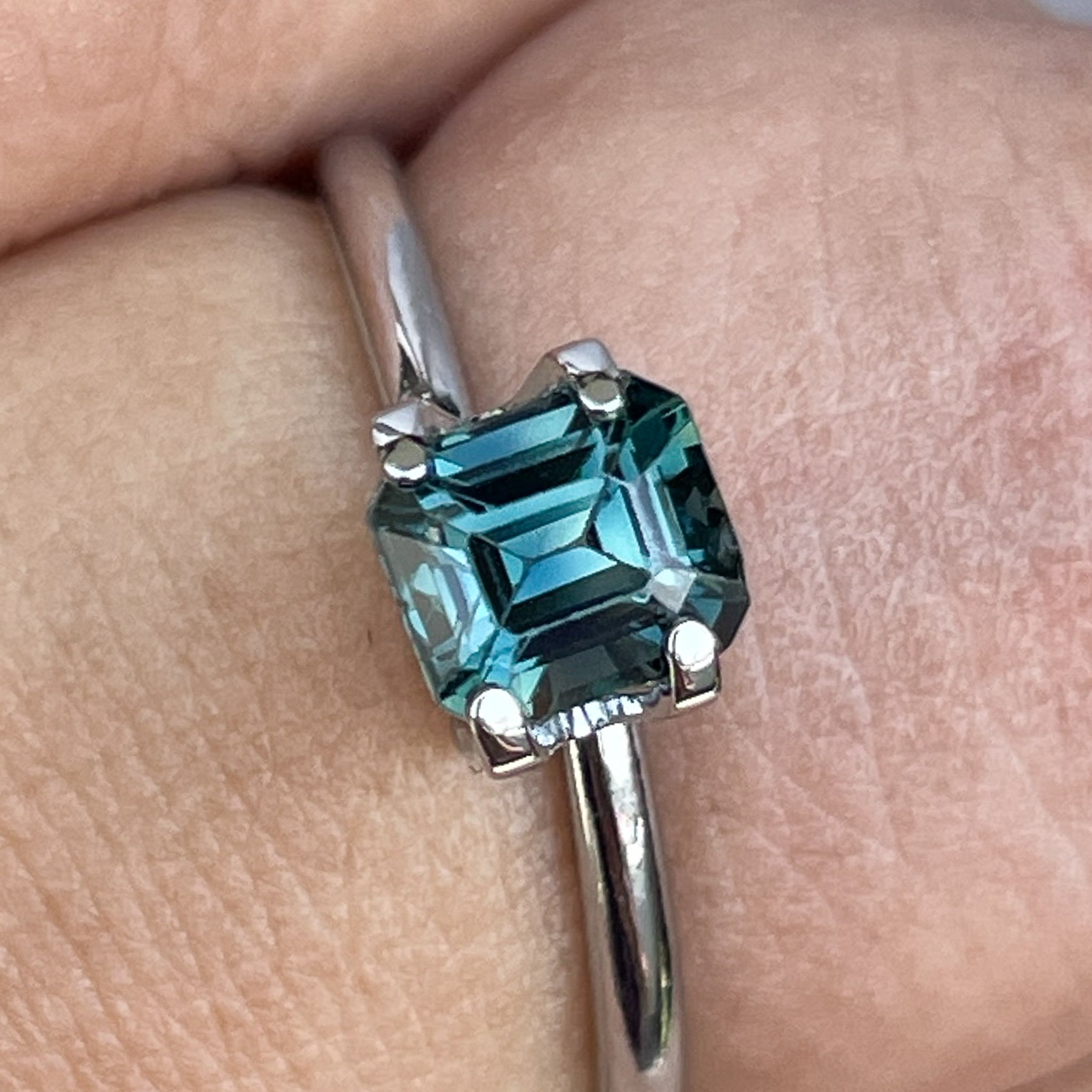 Natural teal blue sapphire 1.06 carats in emerald cut, loose no heat gemstone by NASHGEMS for engagement or custom jewelry.