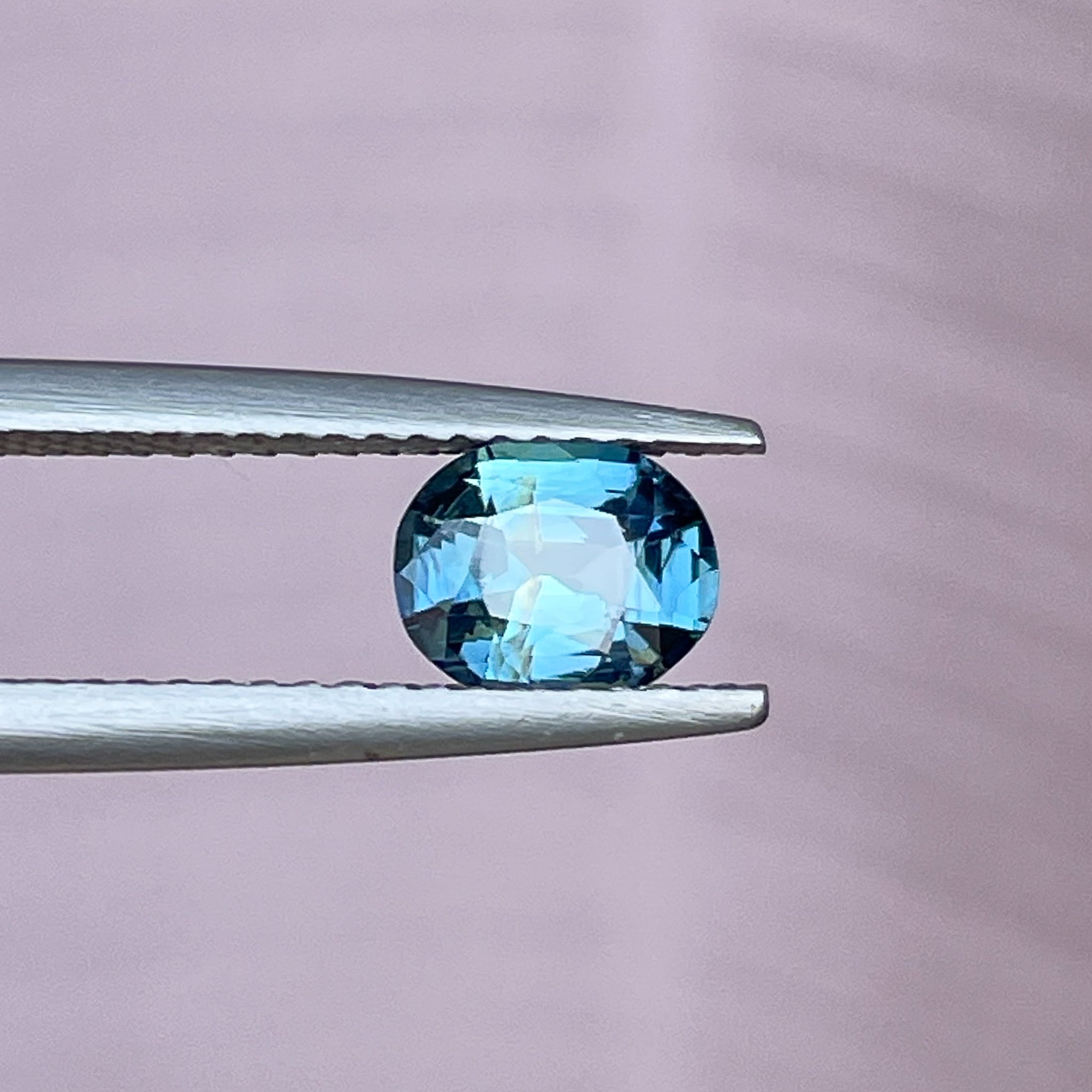 Natural teal sapphire loose stone, 1.03 Ct oval cut, vibrant teal-blue-green gemstone for jewelry or engagement rings.