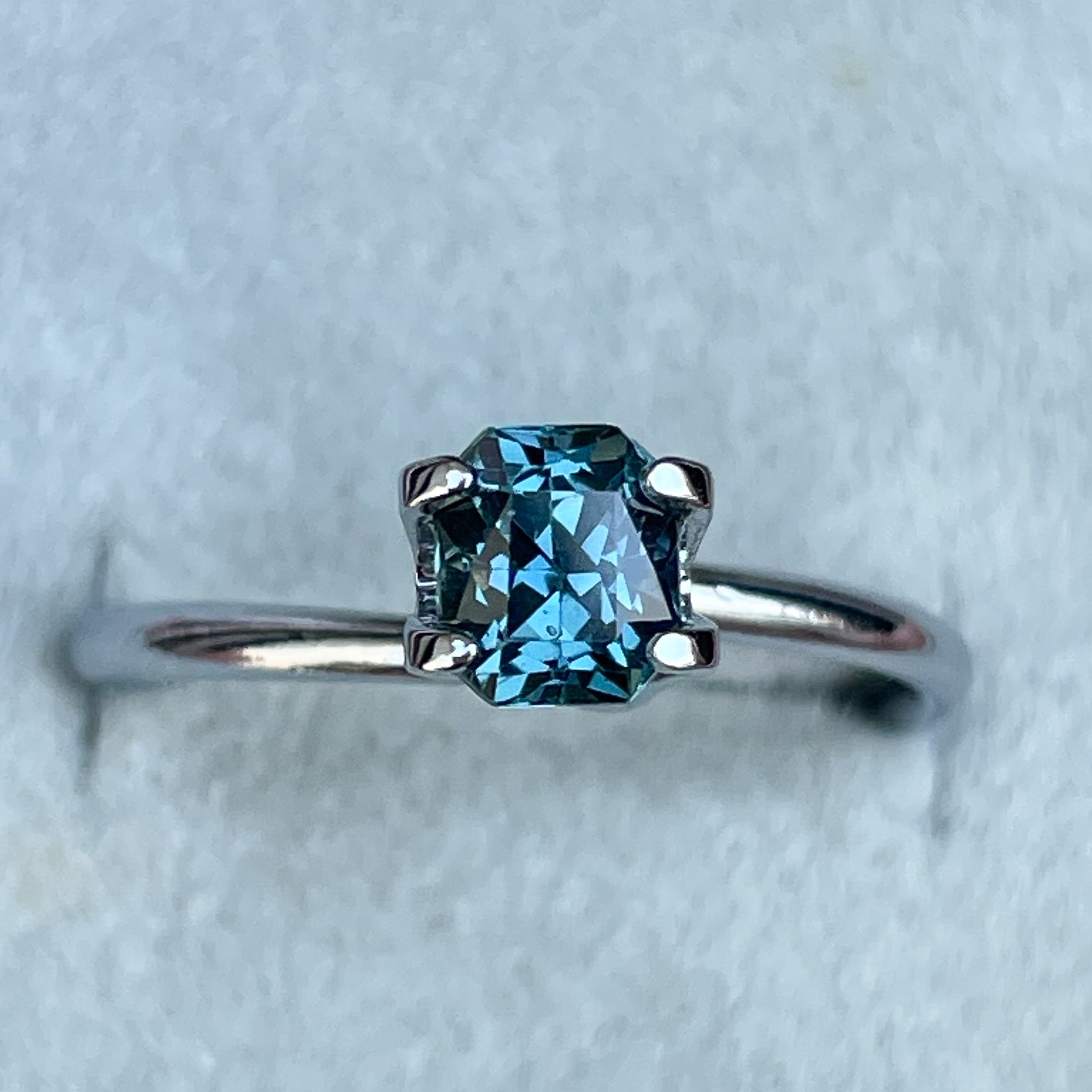 Natural teal blue sapphire 0.98 ct radiant cut loose gemstone from NASHGEMS, ideal for engagement rings or custom jewelry.