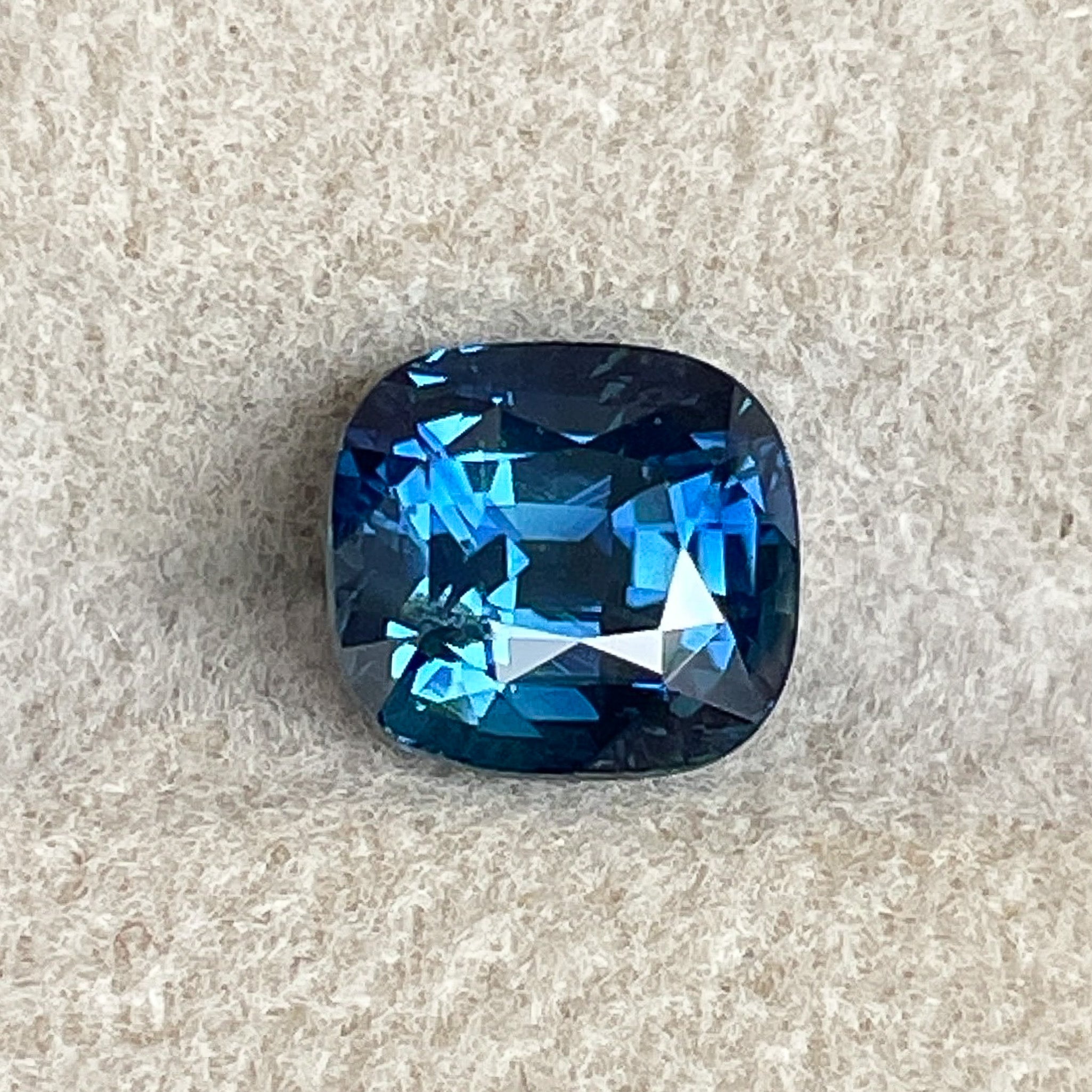 Natural teal blue sapphire, 2.07 Ct cushion cut loose gemstone by NASHGEMS, ideal for engagement rings or custom jewelry.