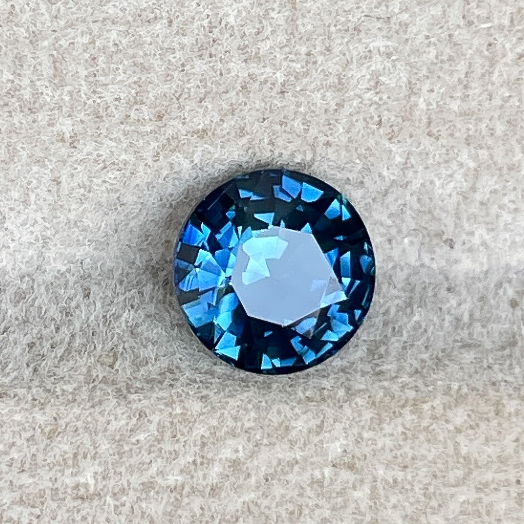 Natural teal blue sapphire, 1.65 Ct round cut loose gemstone by NASHGEMS, ideal for engagement rings or custom jewelry.